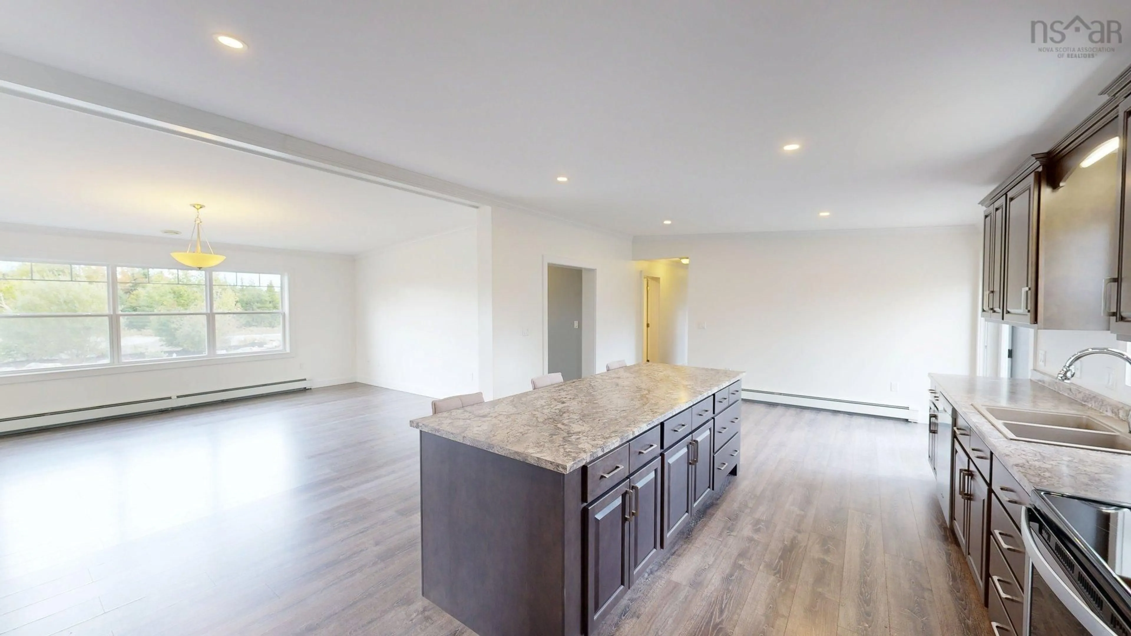 Open concept kitchen, wood/laminate floor for 210 Keltic Drive, Lawrencetown Nova Scotia B2Z 1M5