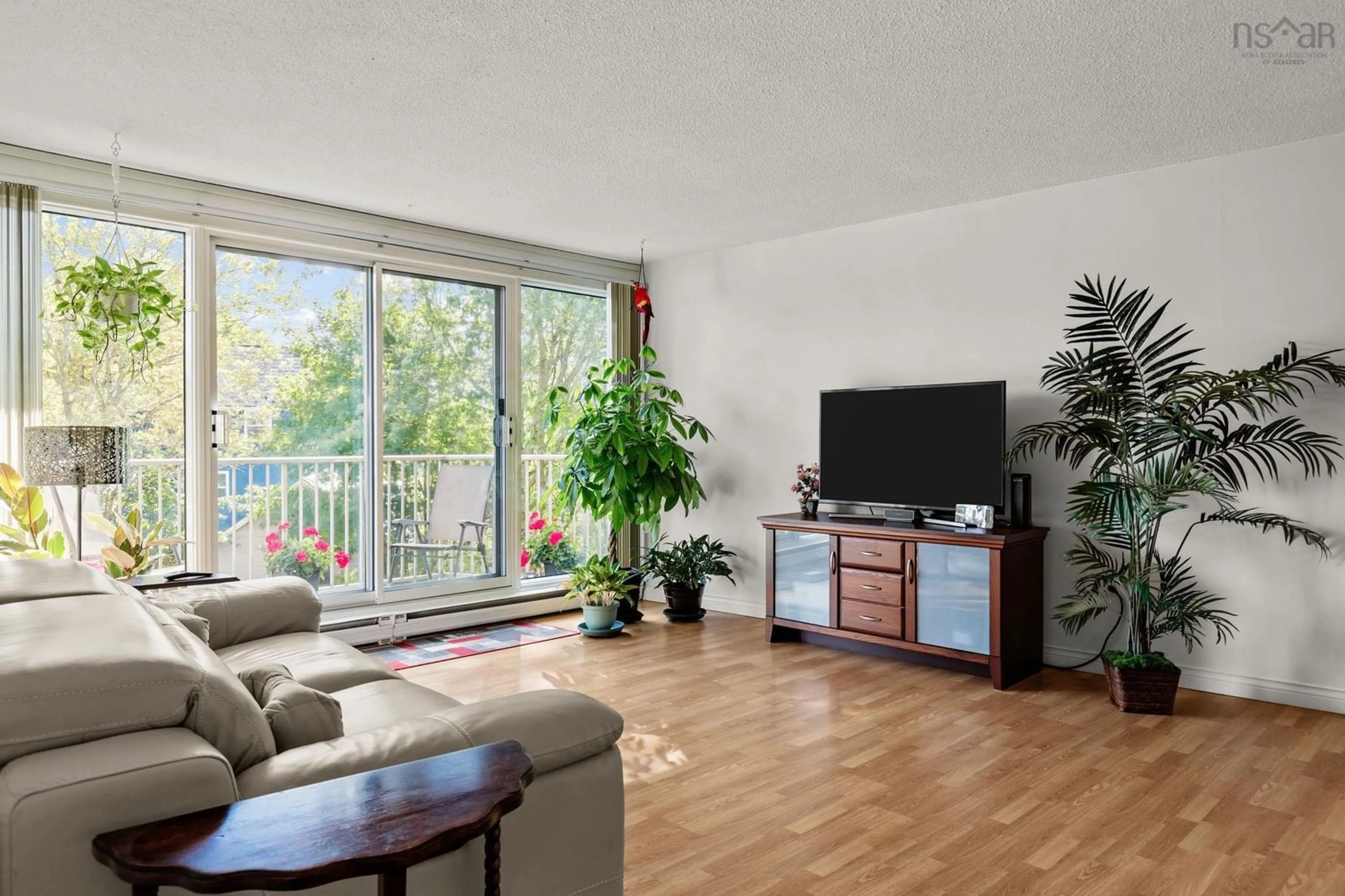 Living room with furniture, wood/laminate floor for 5570 Heatherwood Crt #303, Halifax Nova Scotia B3K 5N7