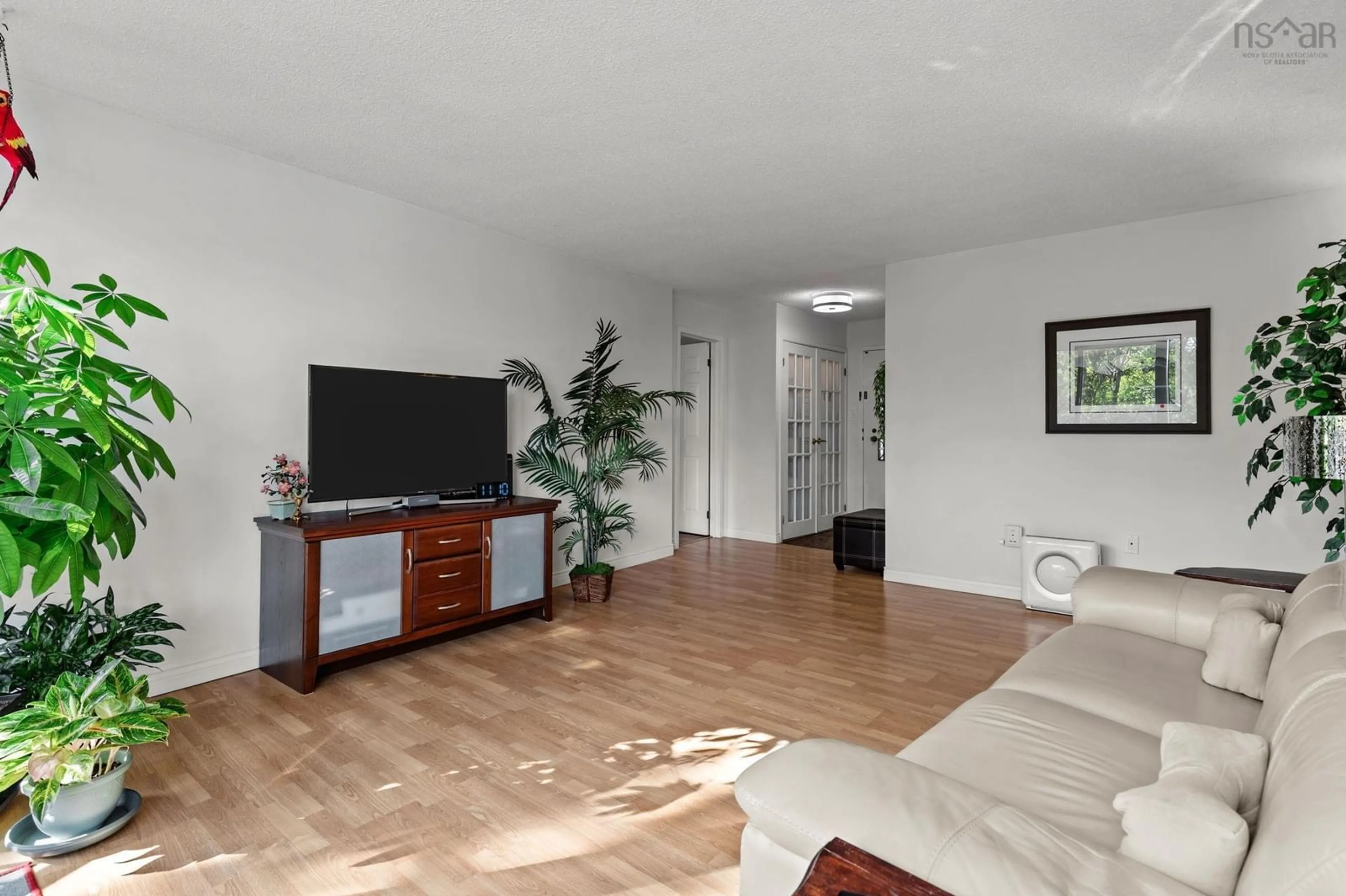 Living room with furniture, wood/laminate floor for 5570 Heatherwood Crt #303, Halifax Nova Scotia B3K 5N7