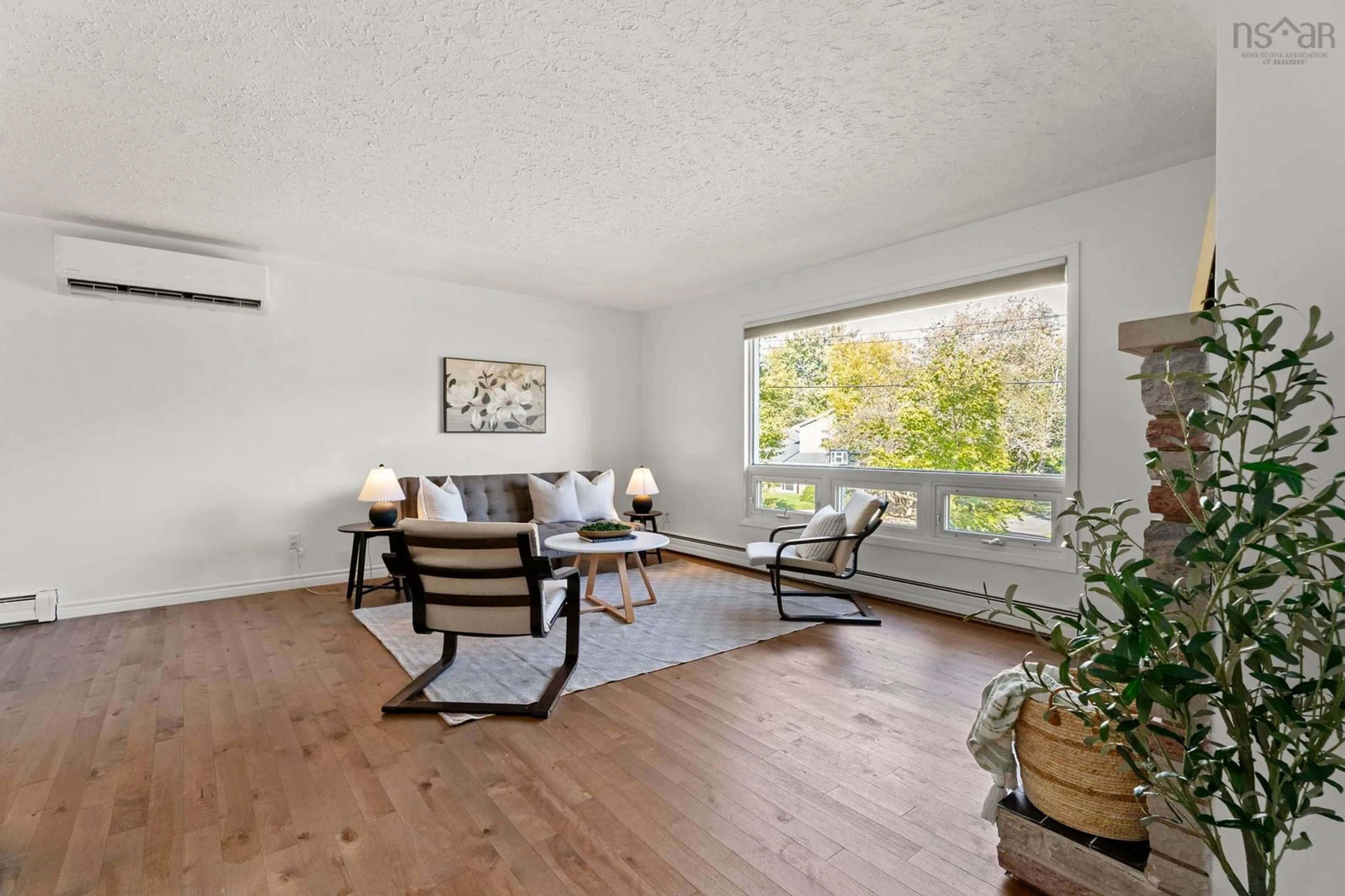 Living room with furniture, wood/laminate floor for 16 Robert Allen Dr, Wedgewood Nova Scotia B3M 3G8