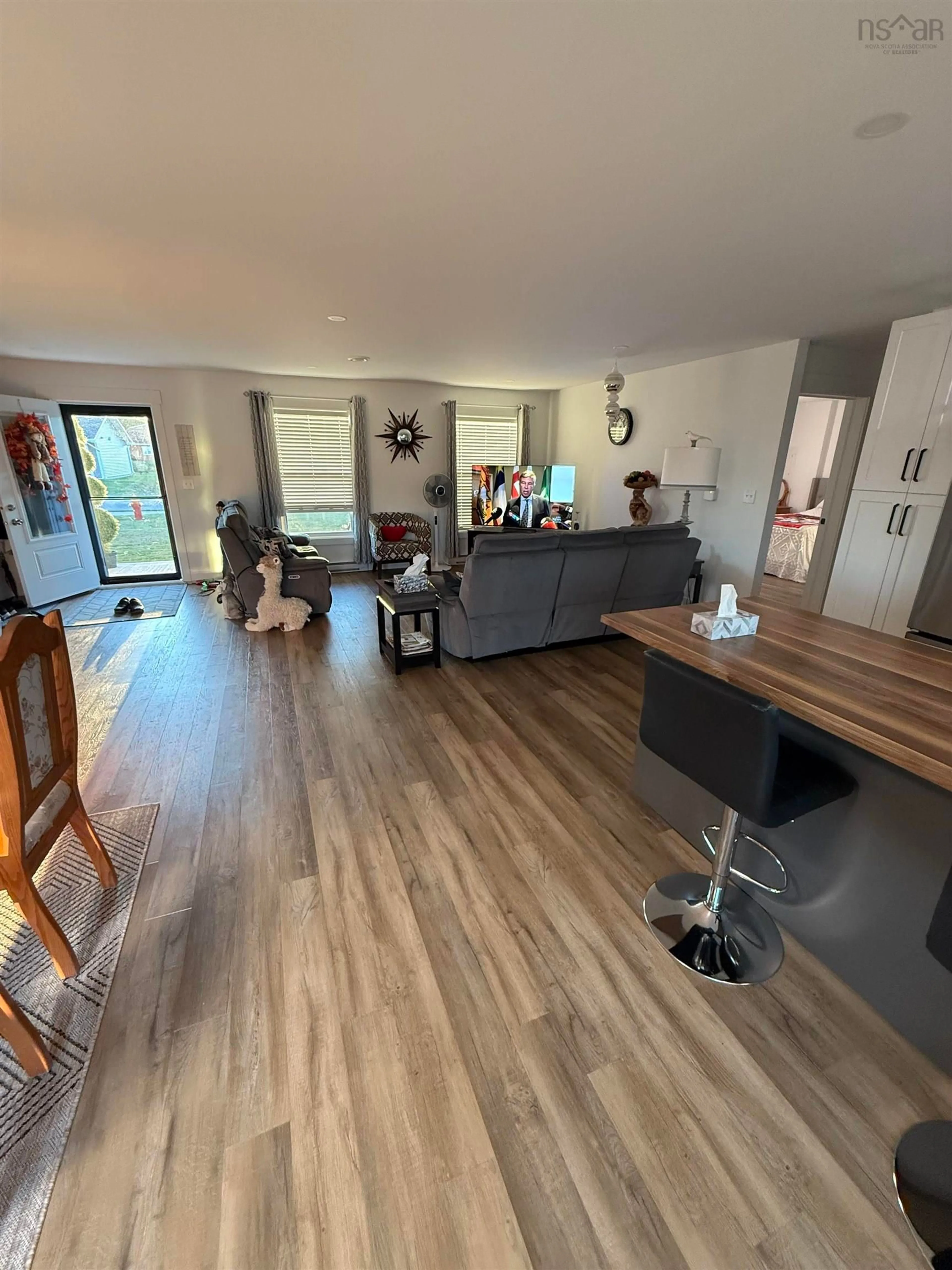 Living room with furniture, wood/laminate floor for 57 Michael St, Sydney Nova Scotia B1P 0J6