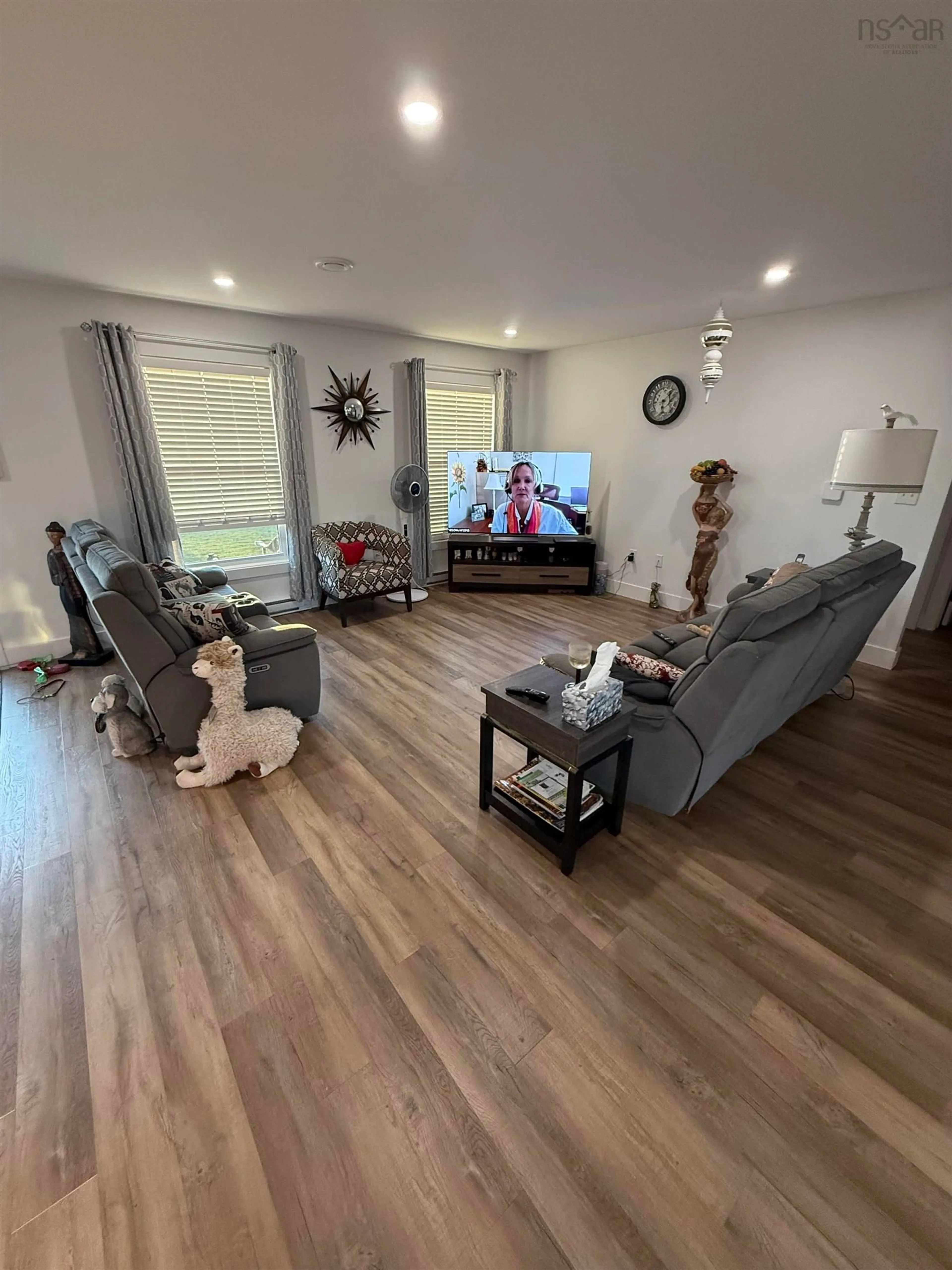 Living room with furniture, wood/laminate floor for 57 Michael St, Sydney Nova Scotia B1P 0J6