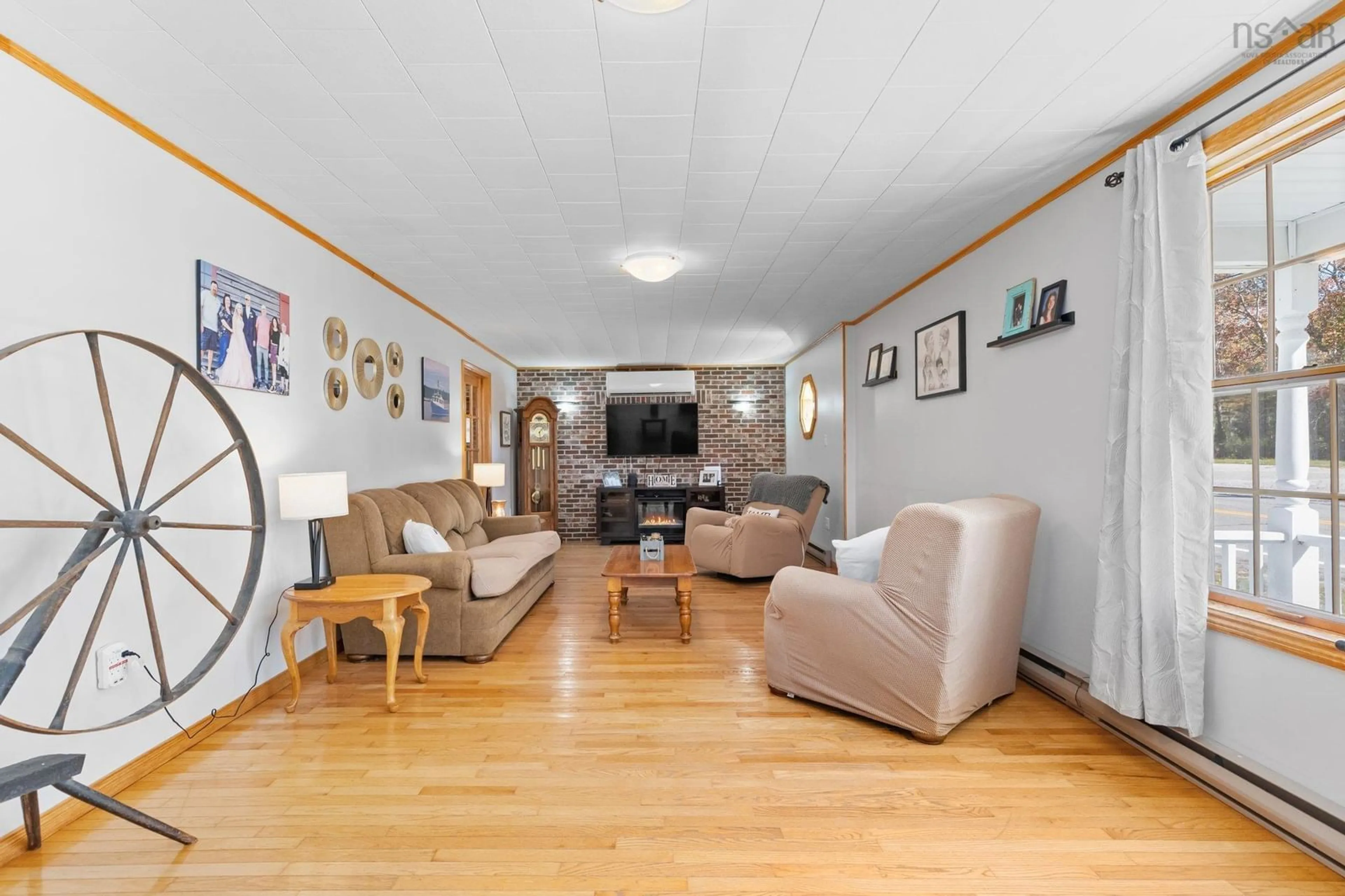 Living room with furniture, wood/laminate floor for 902 Highway 3, Birchtown Nova Scotia B0T 1W0