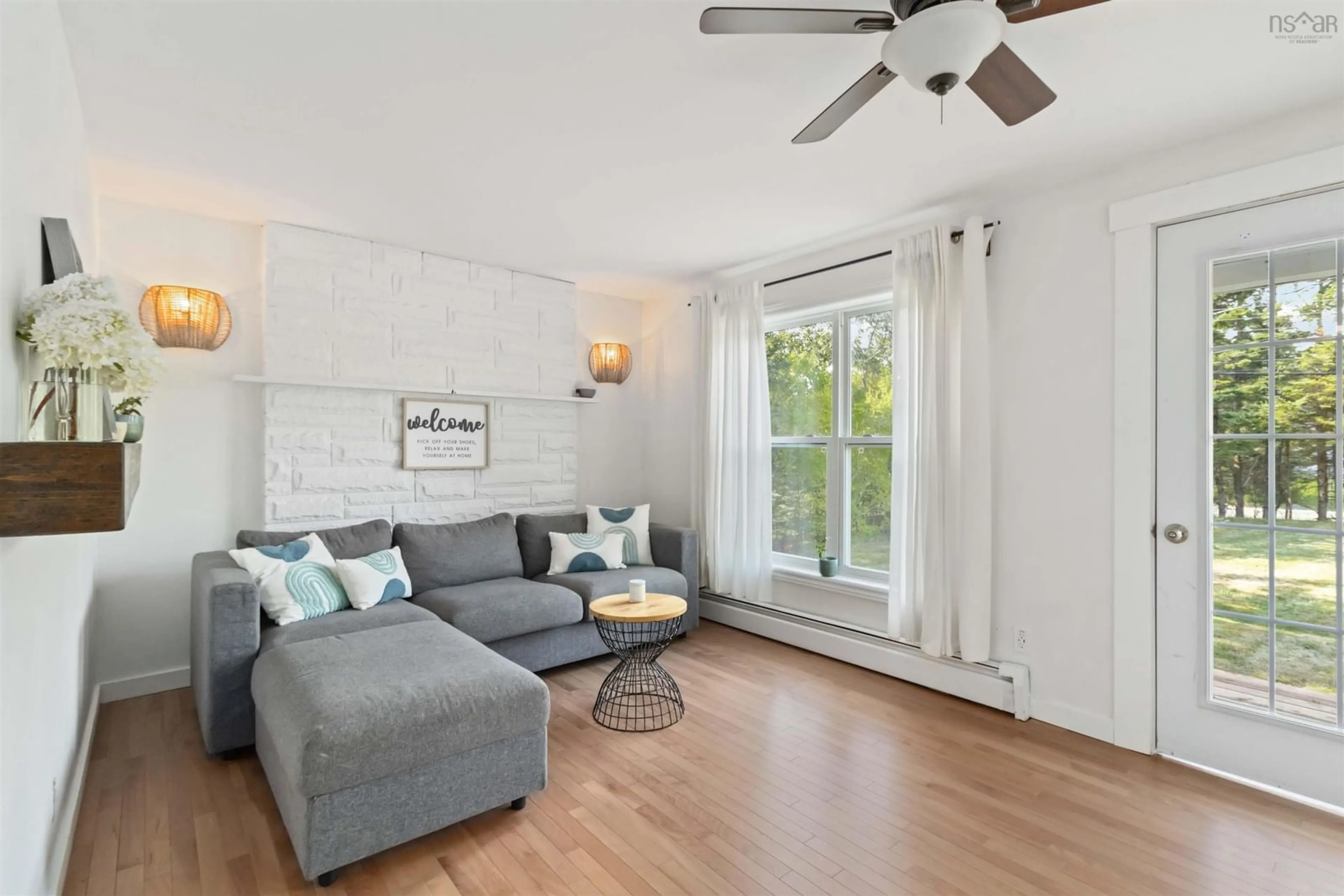 Living room with furniture, wood/laminate floor for 5808 Highway 7, Head Of Chezzetcook Nova Scotia B0J 2L0