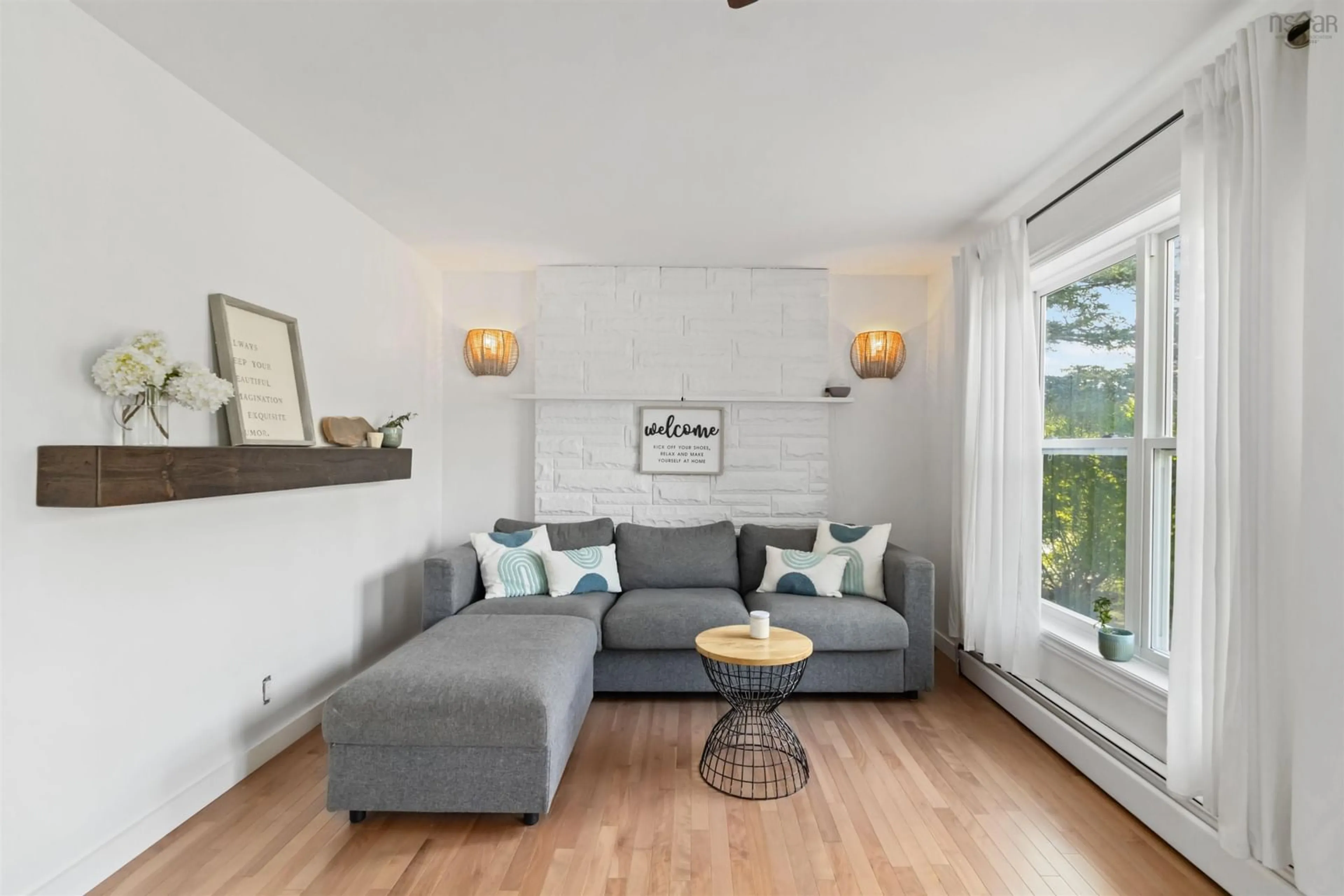 Living room with furniture, wood/laminate floor for 5808 Highway 7, Head Of Chezzetcook Nova Scotia B0J 2L0