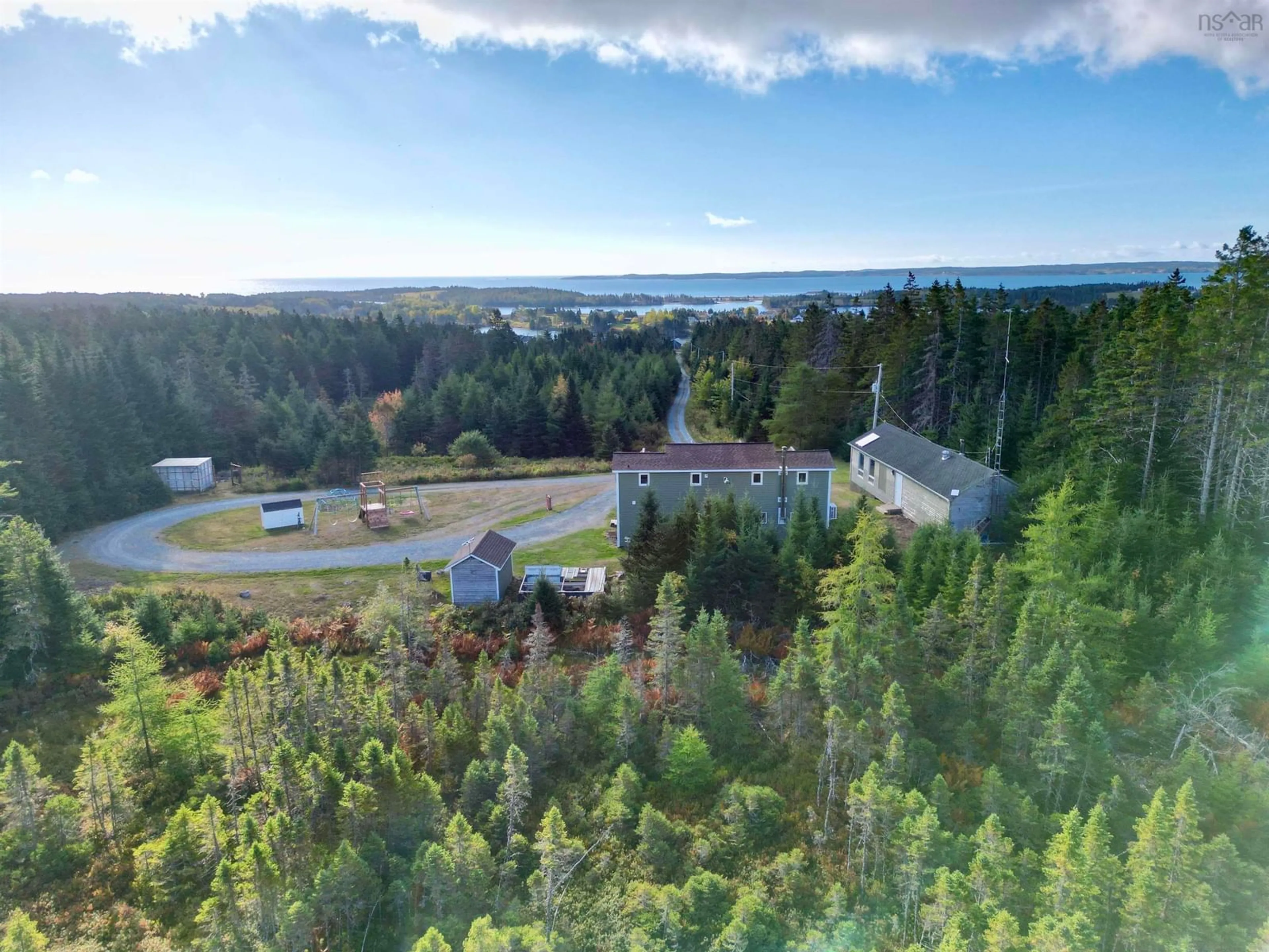 A pic from outside/outdoor area/front of a property/back of a property/a pic from drone, forest/trees view for 8633 Highway 4, River Bourgeois Nova Scotia B0E 2X0