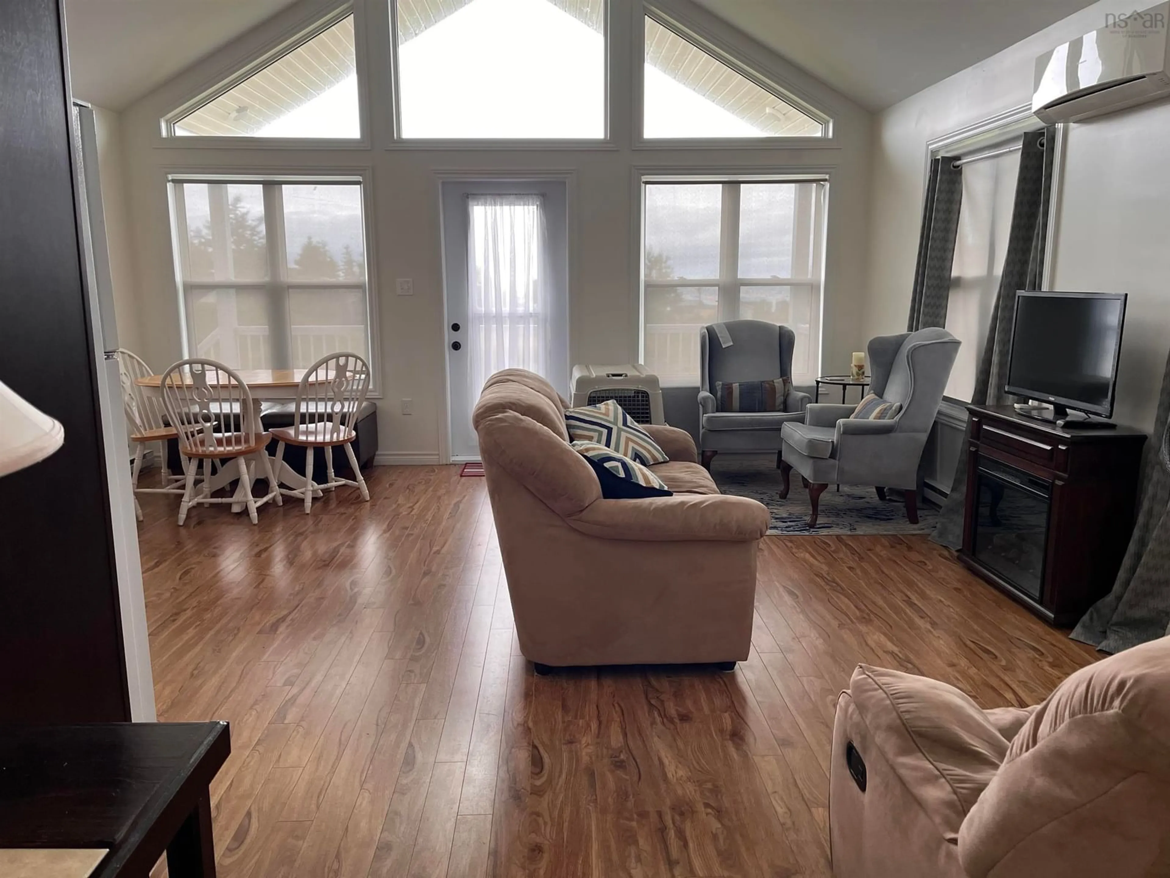 Living room with furniture, wood/laminate floor for 39 Heron Dr, Caribou River Nova Scotia B0K 1H0