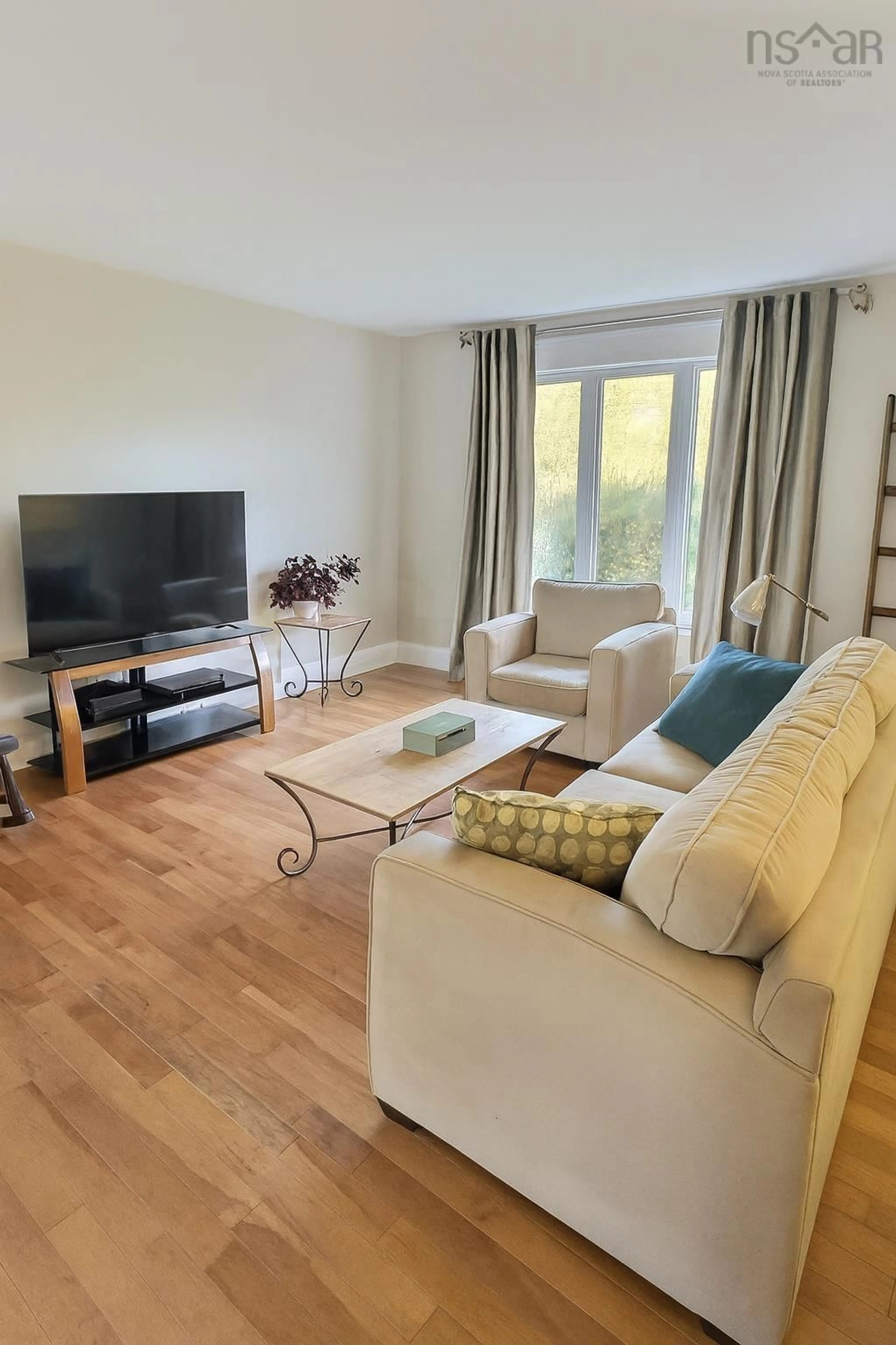 Living room with furniture, wood/laminate floor for 152 Doherty Dr, Lawrencetown Nova Scotia B2Z 1C8