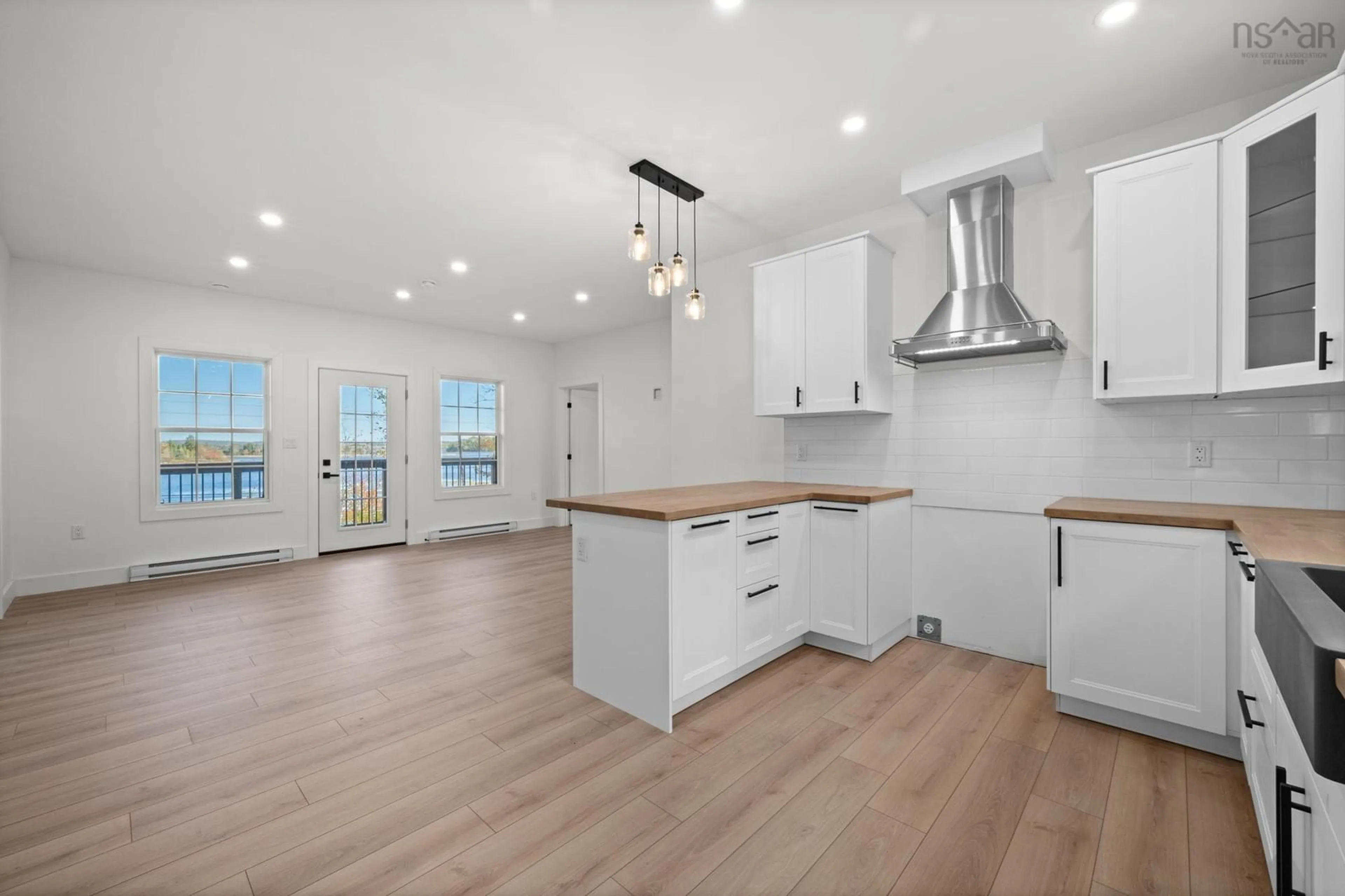 Open concept kitchen, wood/laminate floor for 67 Birchview Dr, Lake Charlotte Nova Scotia B0J 2L0
