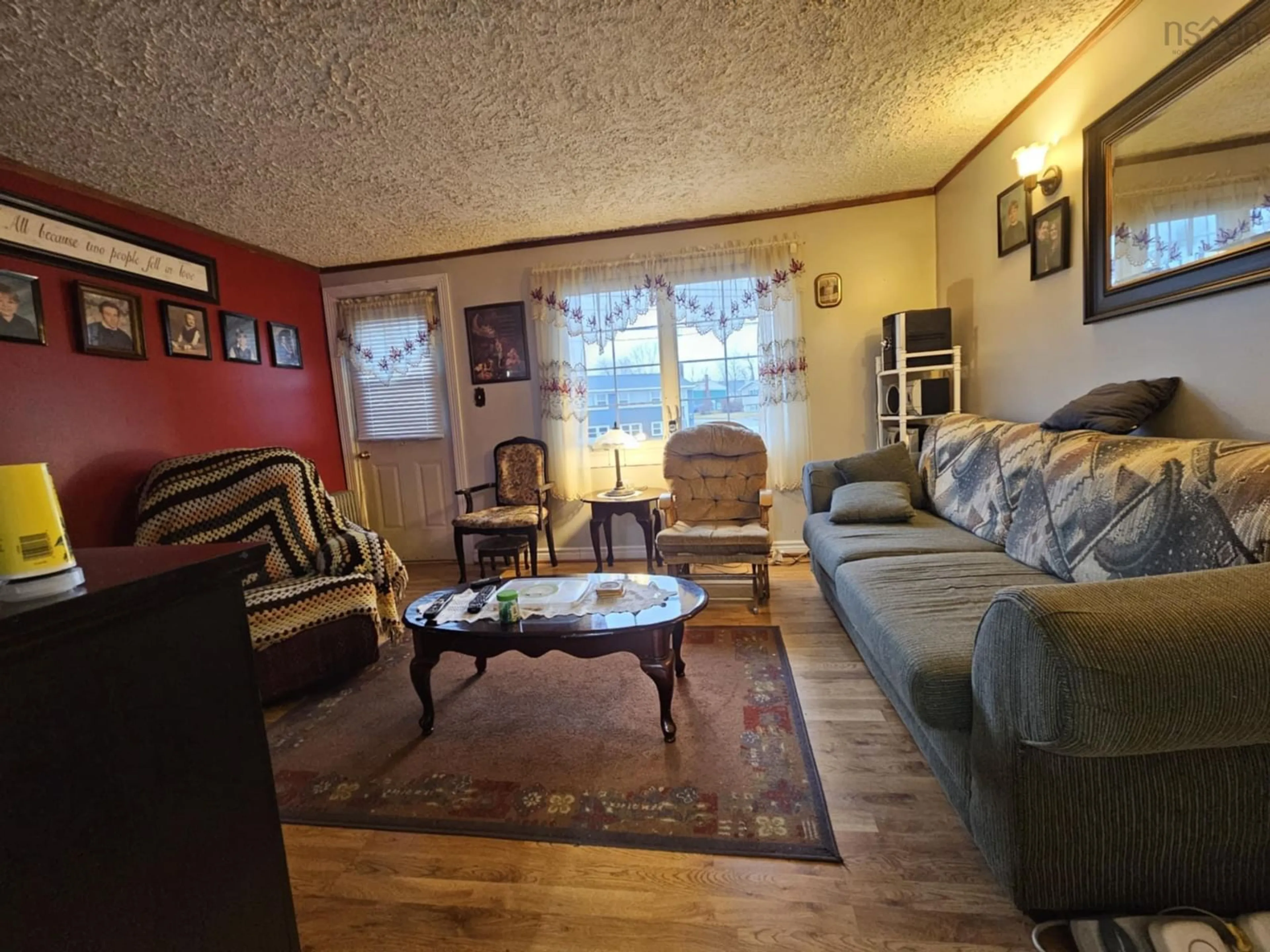 Living room with furniture, wood/laminate floor for 815 Upper Prince St, Sydney Nova Scotia B1P 5N4