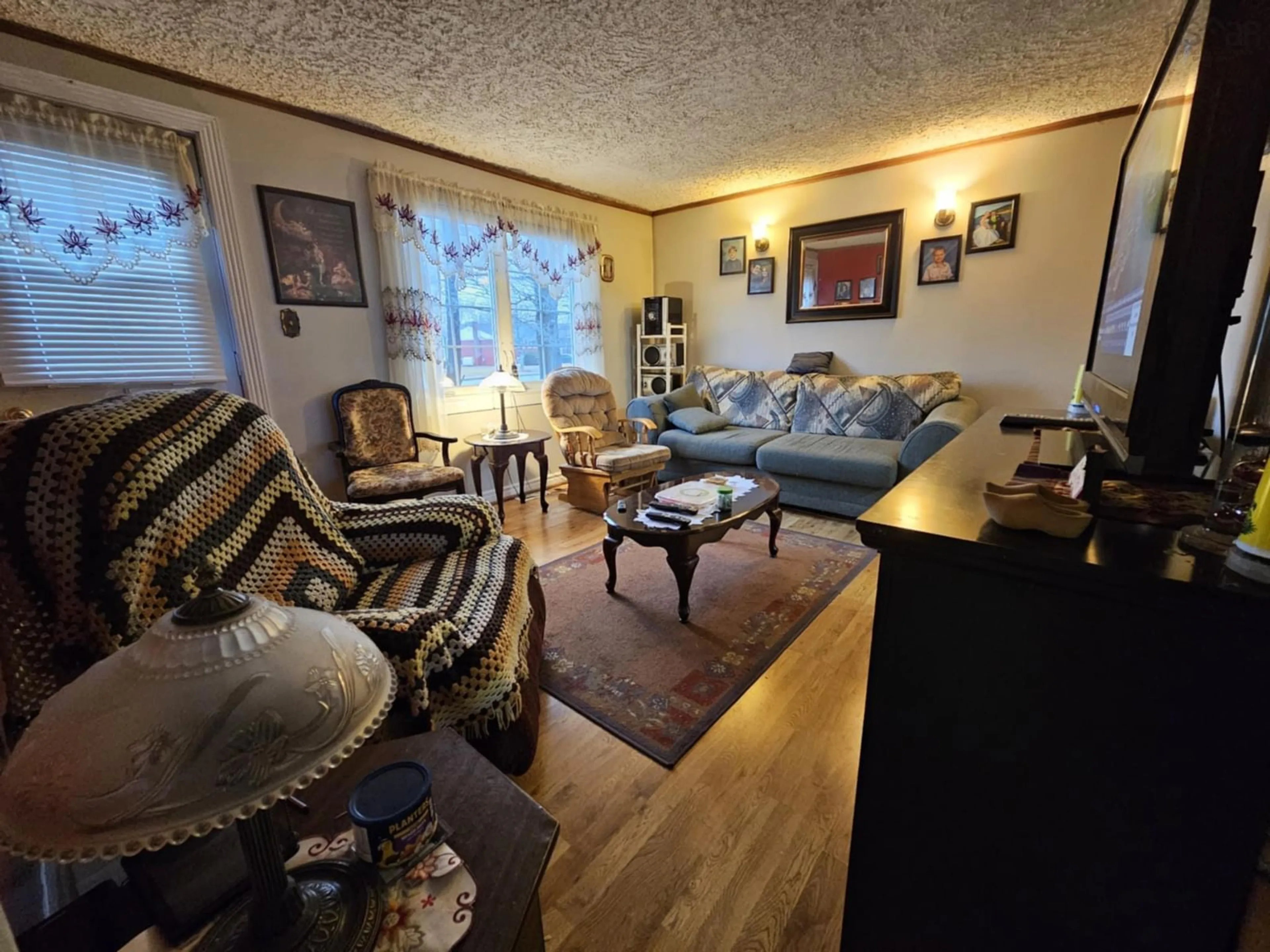 Living room with furniture, wood/laminate floor for 815 Upper Prince St, Sydney Nova Scotia B1P 5N4
