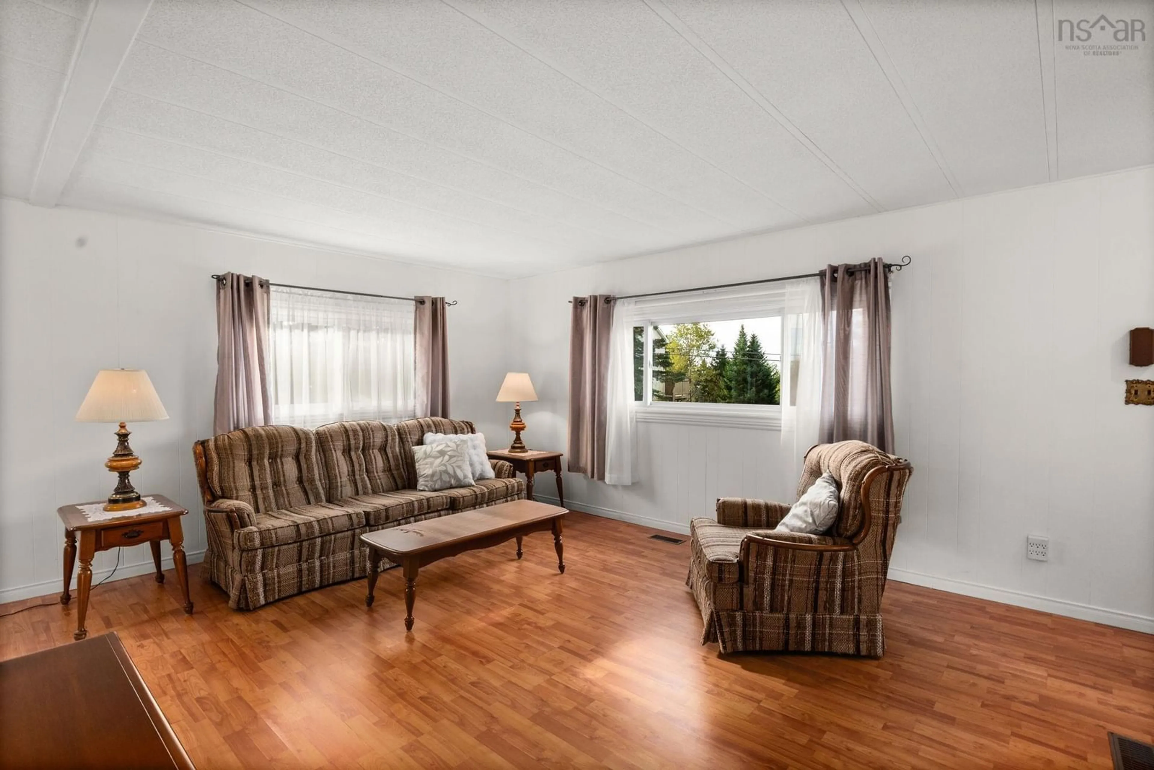 Living room with furniture, wood/laminate floor for 24 Moore Dr, Lawrencetown Nova Scotia B2Z 1R2