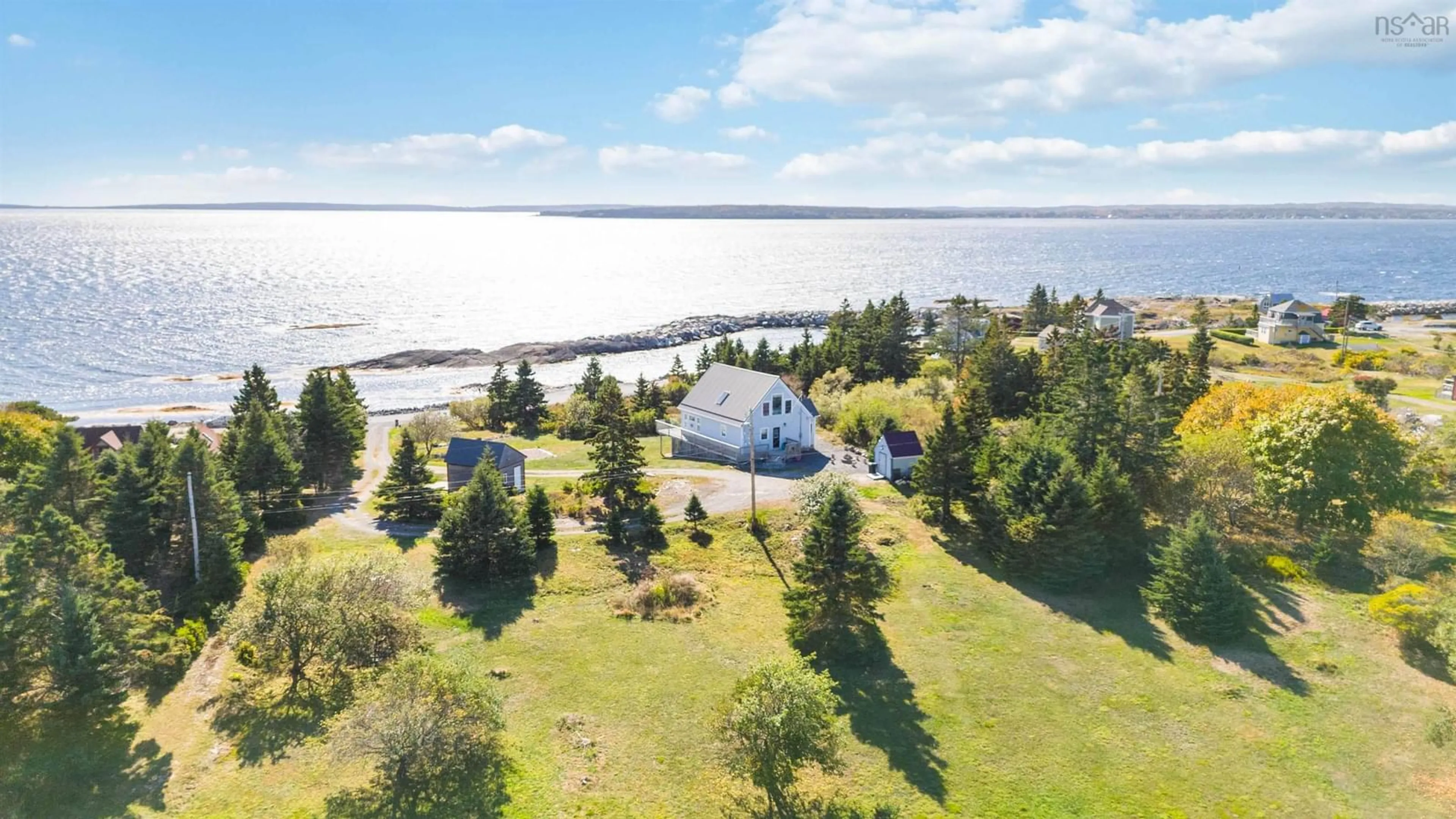 A pic from outside/outdoor area/front of a property/back of a property/a pic from drone, water/lake/river/ocean view for 157 The Point Rd, Blue Rocks Nova Scotia B0J 2C0