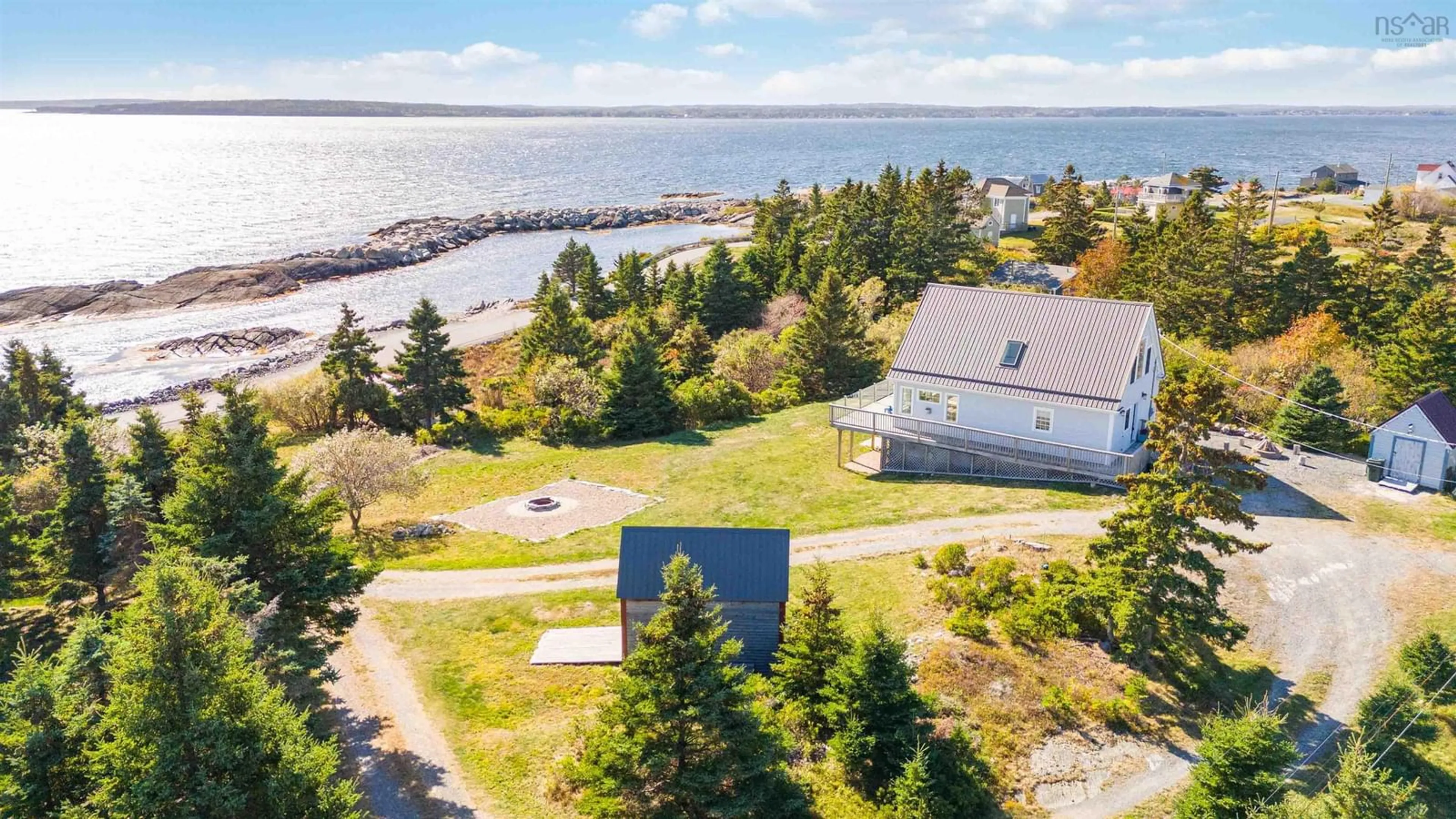 A pic from outside/outdoor area/front of a property/back of a property/a pic from drone, water/lake/river/ocean view for 157 The Point Rd, Blue Rocks Nova Scotia B0J 2C0