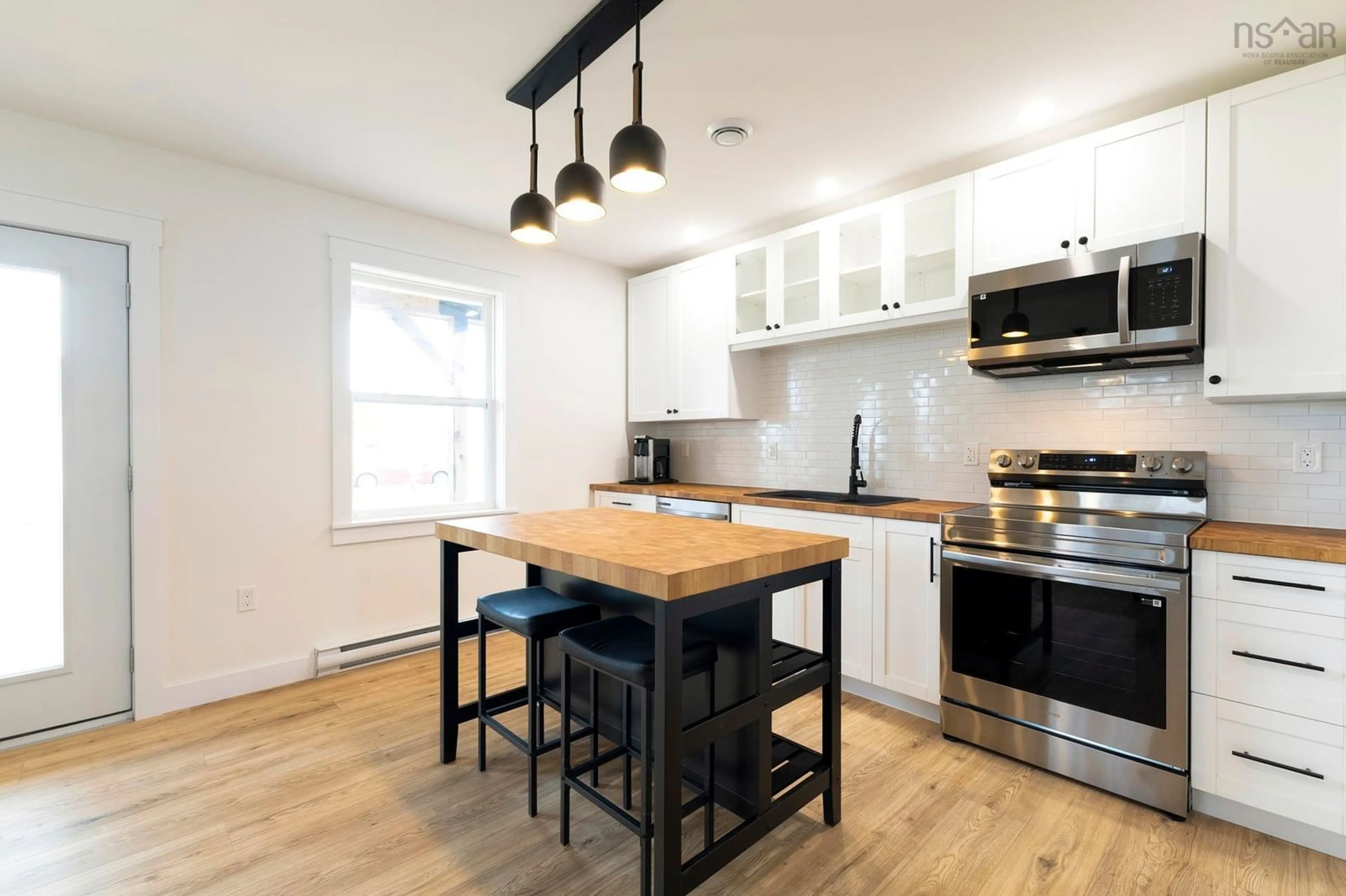 Open concept kitchen, wood/laminate floor for 58 Oak St, Pictou Nova Scotia B0K 1H0
