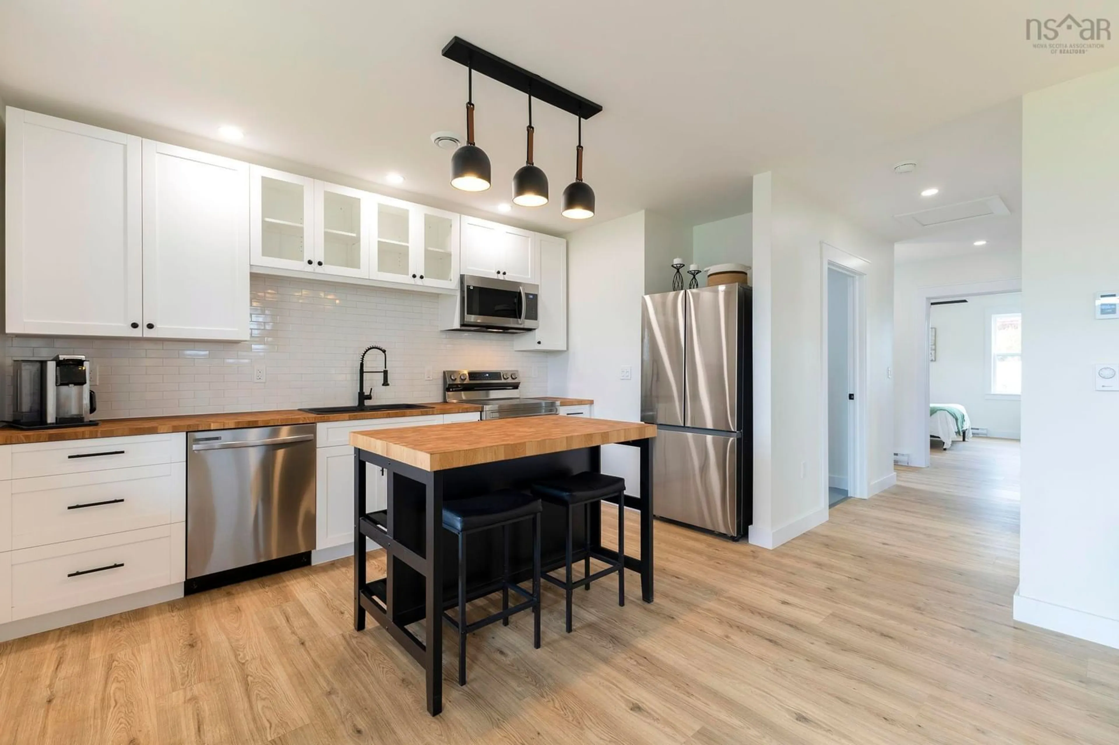 Open concept kitchen, wood/laminate floor for 58 Oak St, Pictou Nova Scotia B0K 1H0