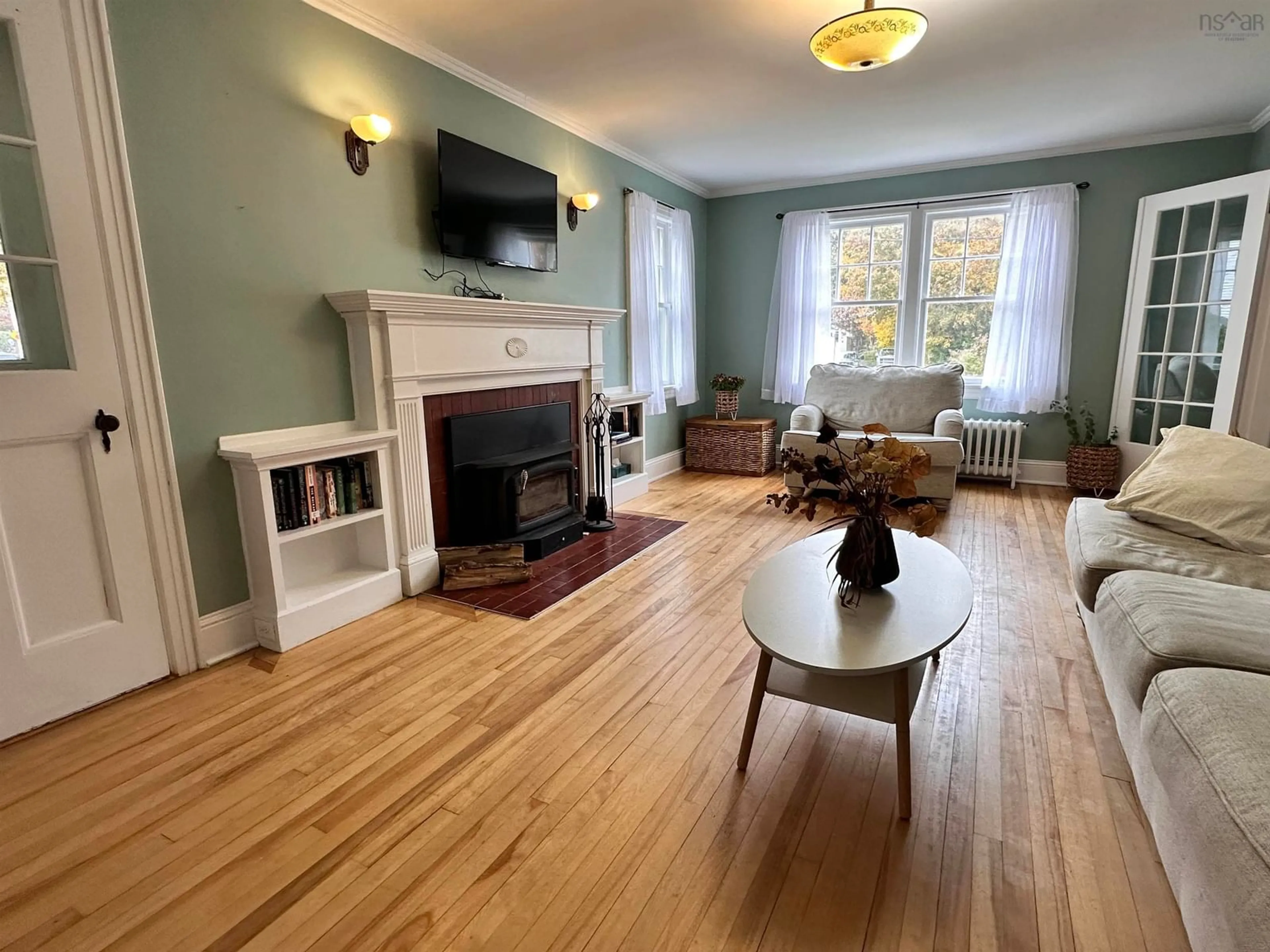 Living room with furniture, wood/laminate floor for 79 Waterloo St, Liverpool Nova Scotia B0T 1K0