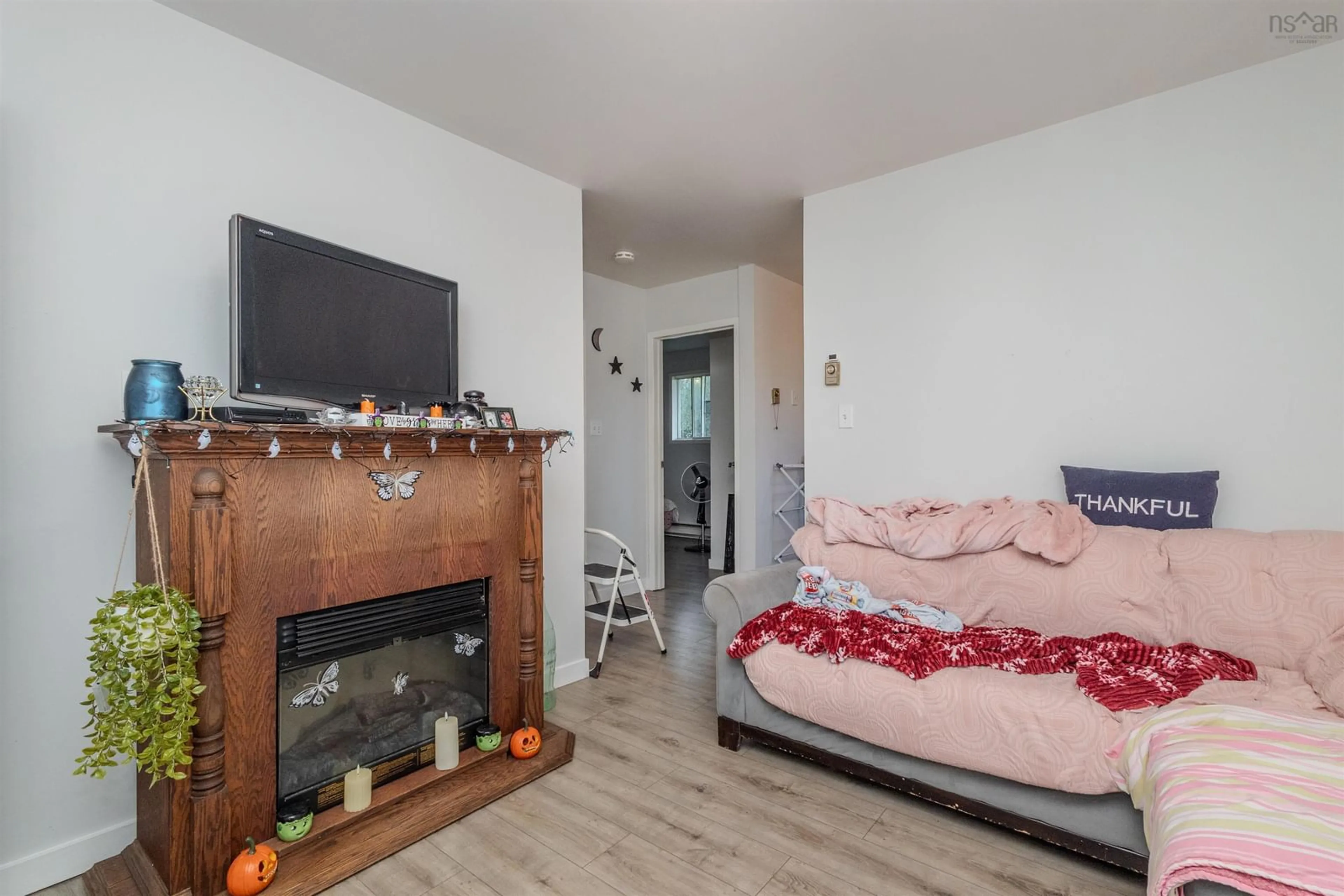 Living room with furniture, wood/laminate floor for 19 Holland St, Reserve Mines Nova Scotia B1E 1C2