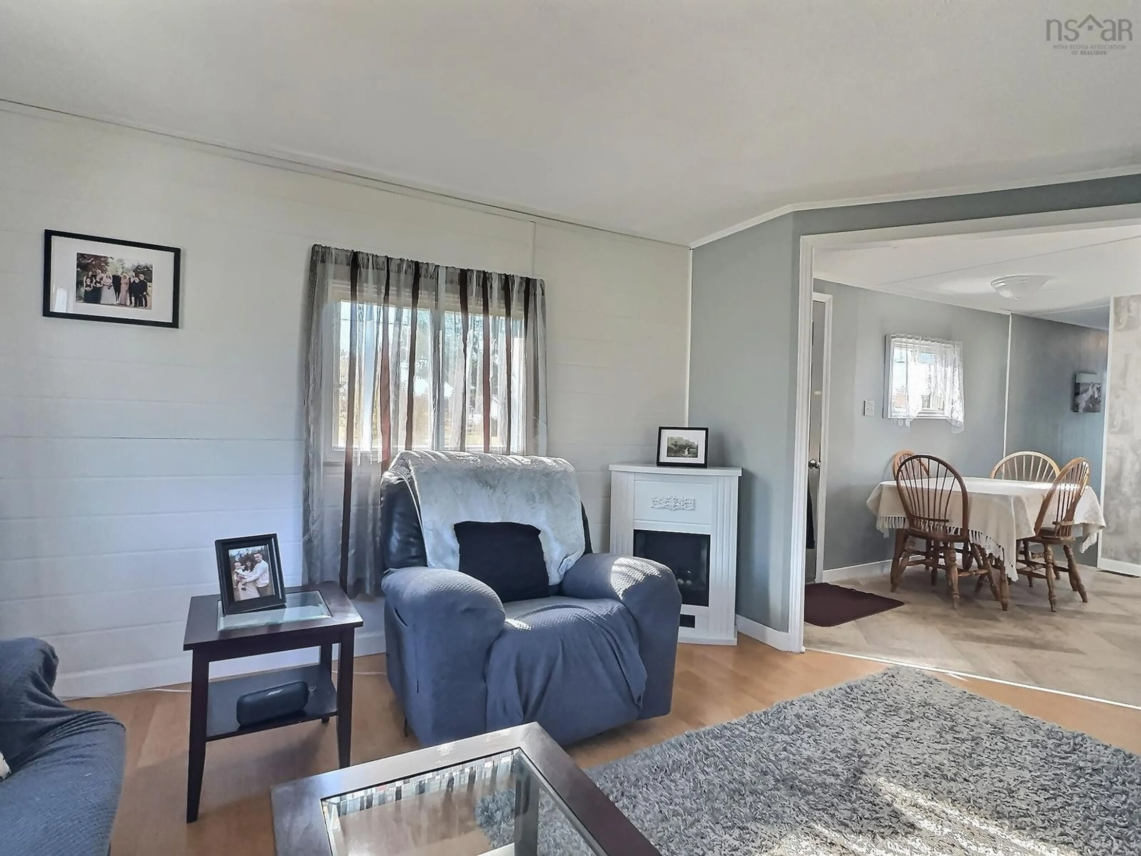 Living room with furniture, wood/laminate floor for 7067 2 Hwy, Portapique Nova Scotia B0M 1B0