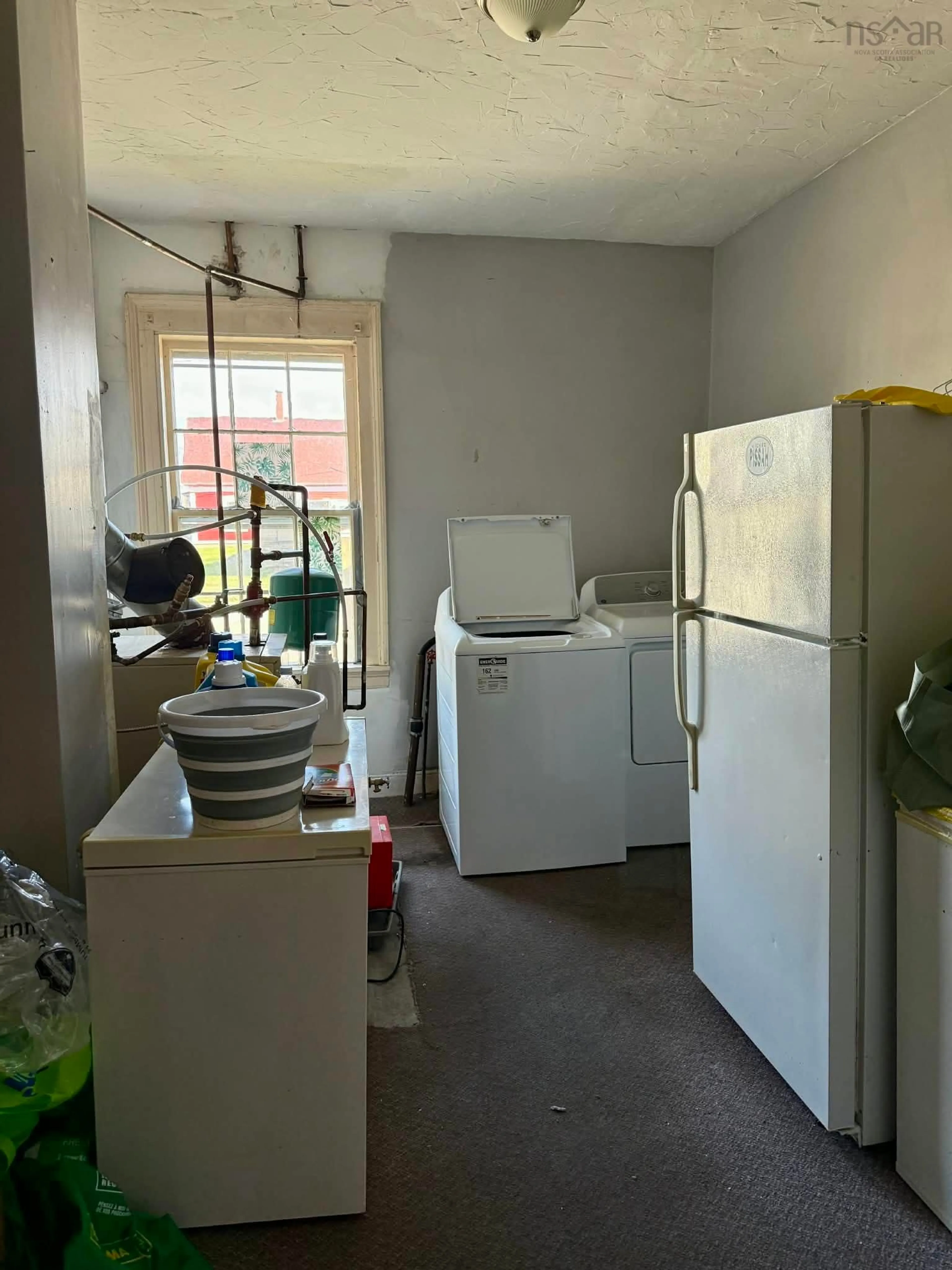 Kitchen with laundary machines, floor is not visible for 27 Starrs Rd, Yarmouth Nova Scotia B5A 2S9
