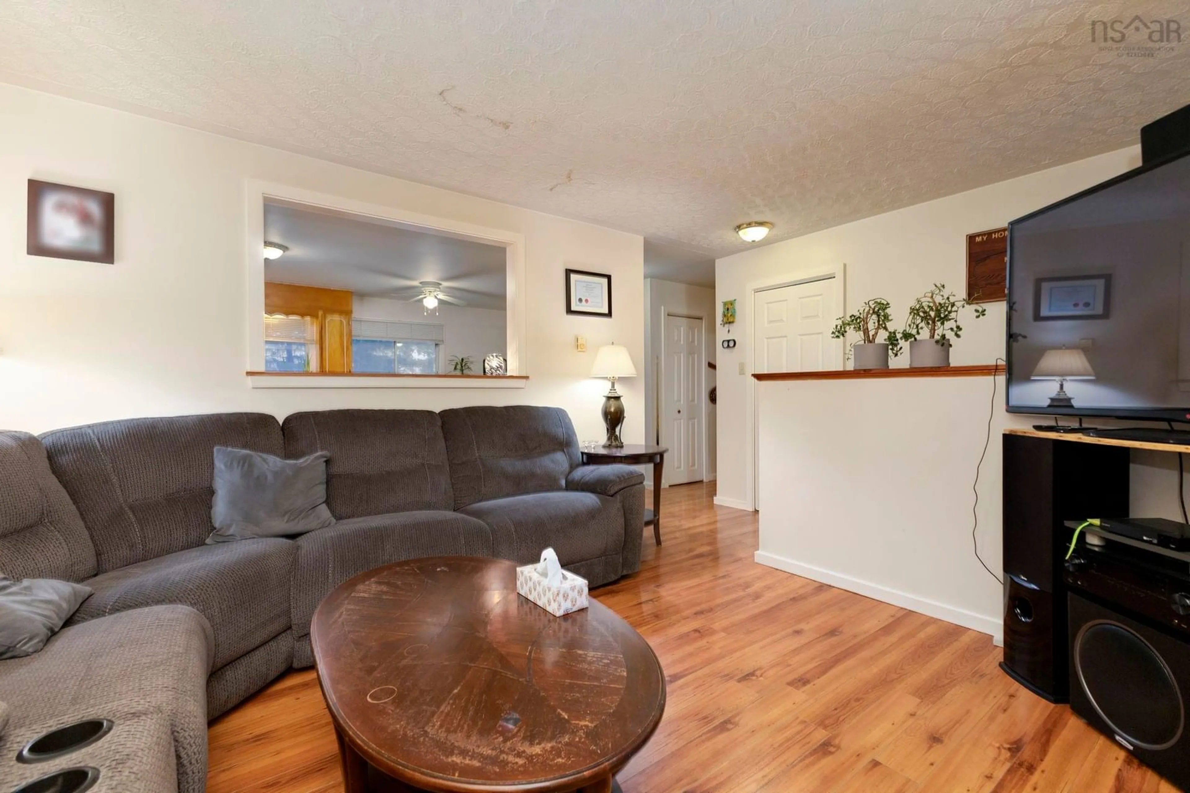 Living room with furniture, wood/laminate floor for 109 & 111 Glenwood Dr, Truro Nova Scotia B2N 6V9