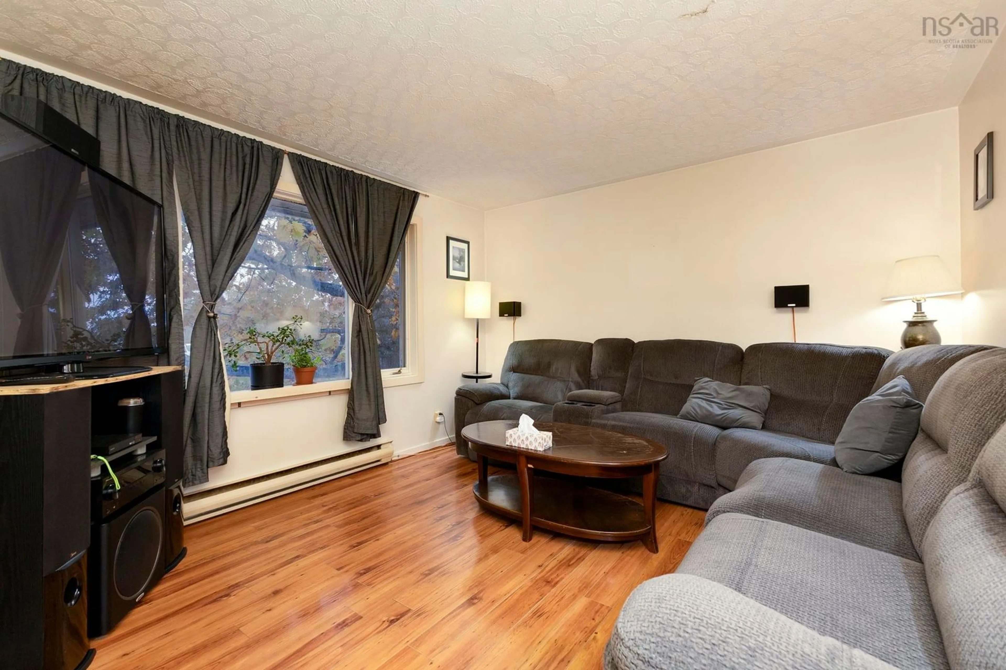 Living room with furniture, wood/laminate floor for 109 & 111 Glenwood Dr, Truro Nova Scotia B2N 6V9