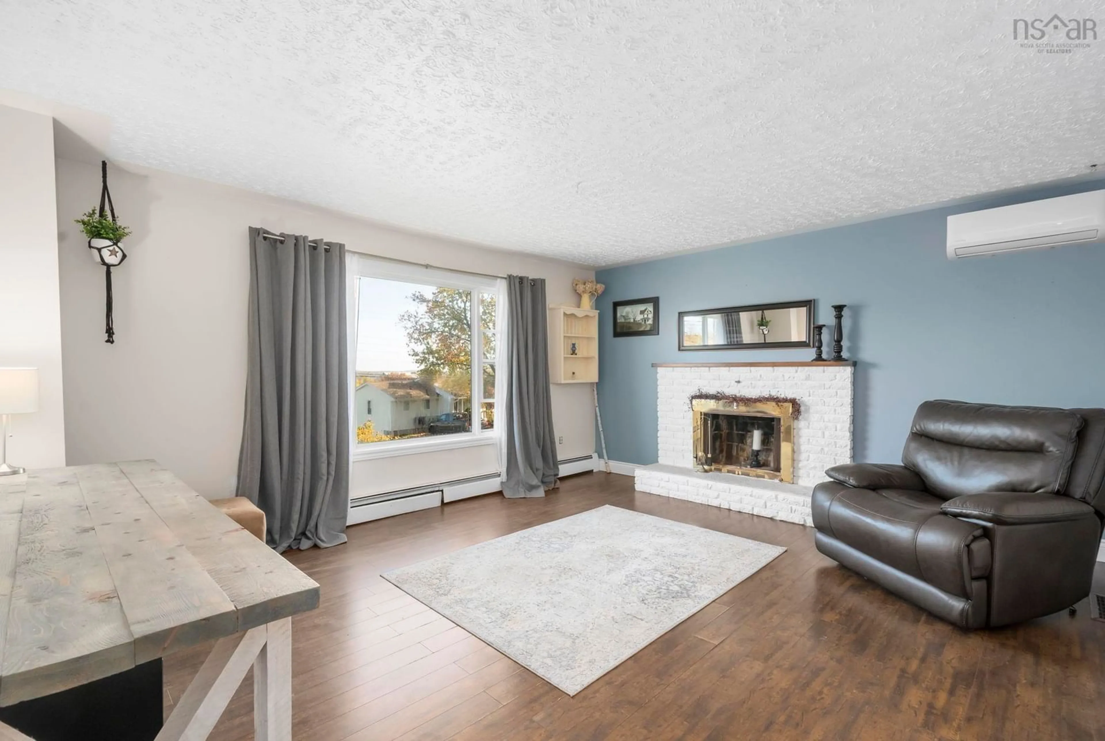 Living room with furniture, wood/laminate floor for 25 Maple Ave, Hantsport Nova Scotia B0P 1P0