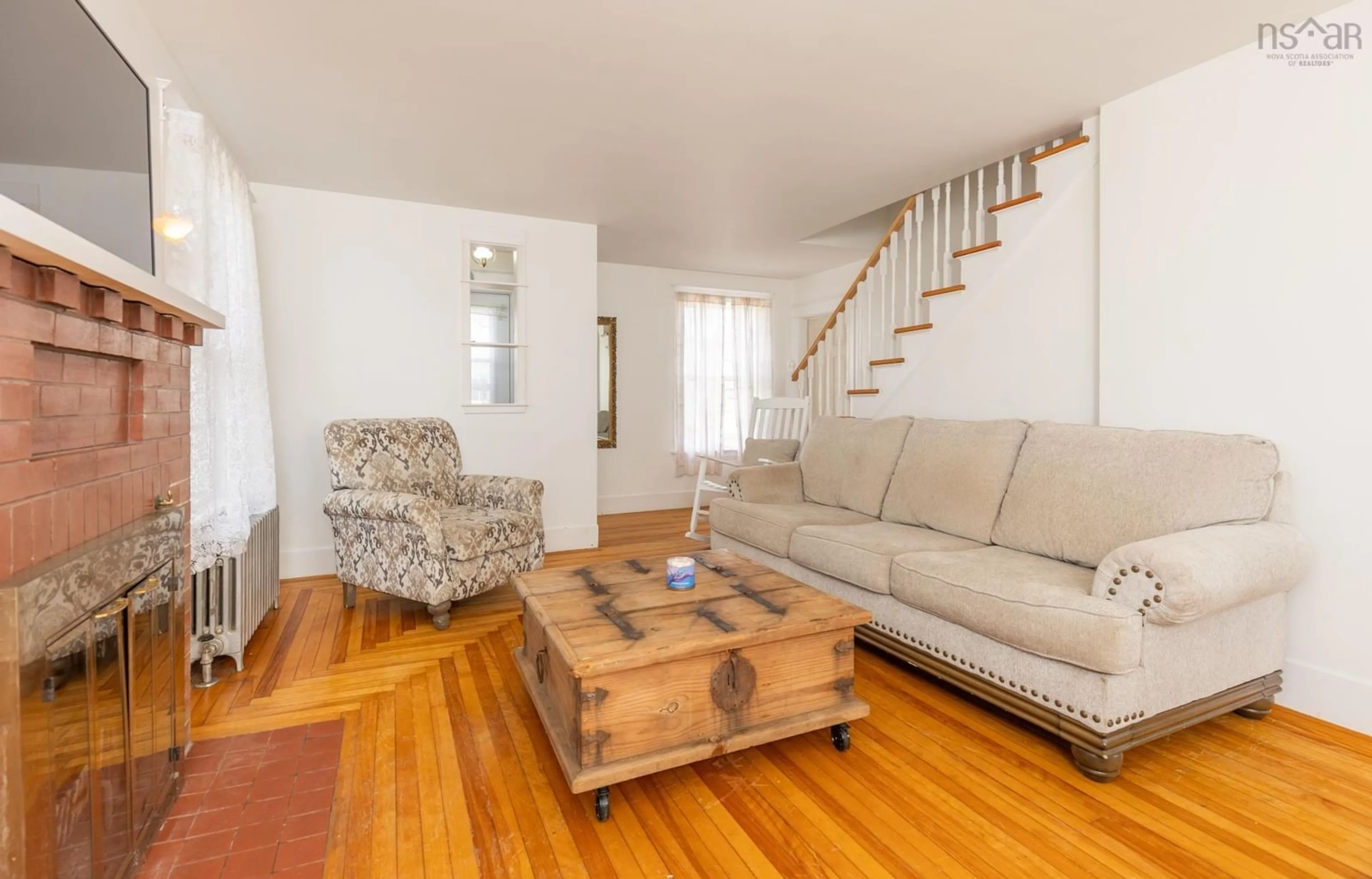 Living room with furniture, wood/laminate floor for 91 Cliff St, Yarmouth Nova Scotia B5A 3J7