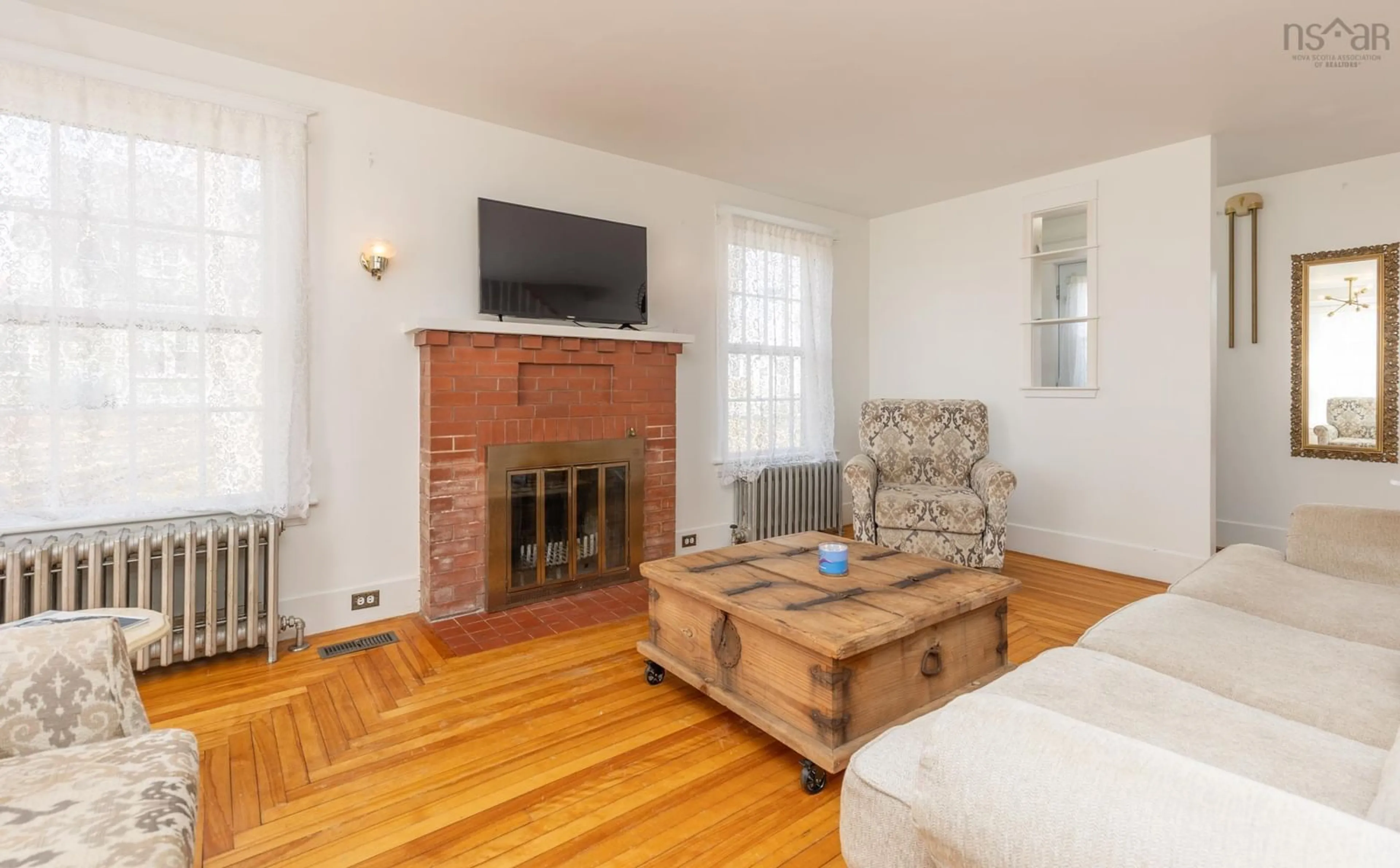 Living room with furniture, wood/laminate floor for 91 Cliff St, Yarmouth Nova Scotia B5A 3J7