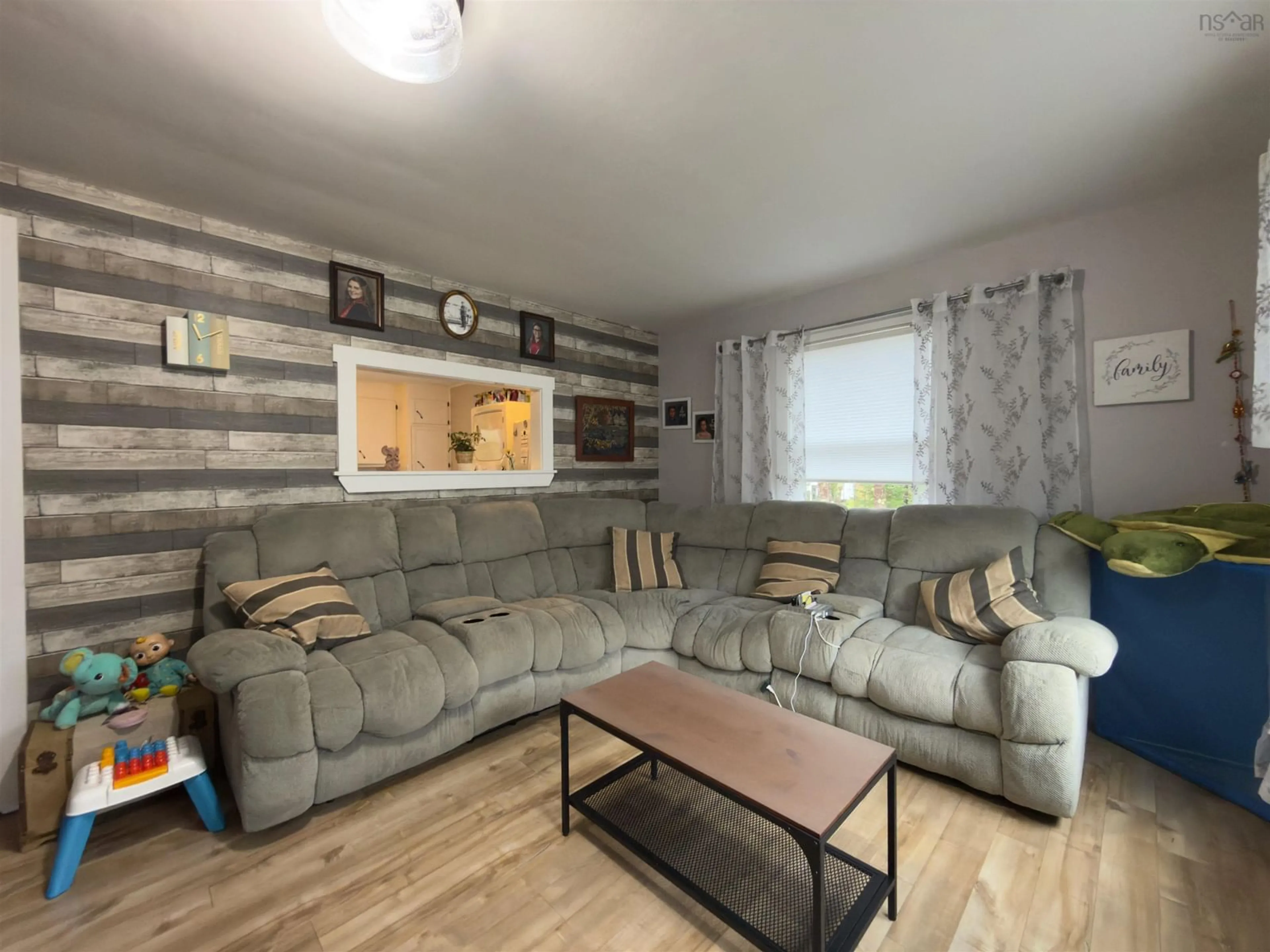 Living room with furniture, wood/laminate floor for 1090 Main Shore Rd, North Chegoggin Nova Scotia B5A 5H2