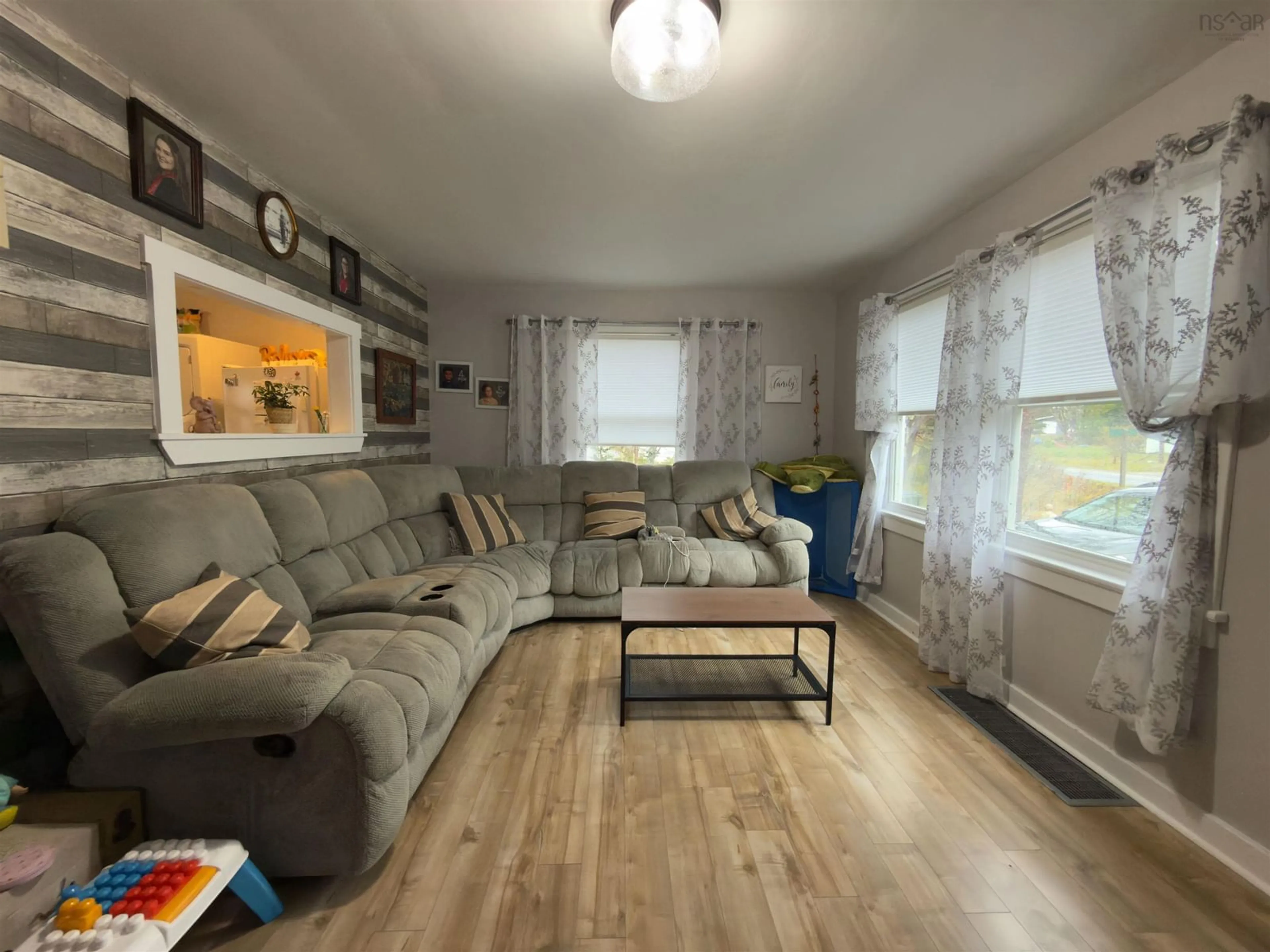 Living room with furniture, wood/laminate floor for 1090 Main Shore Rd, North Chegoggin Nova Scotia B5A 5H2