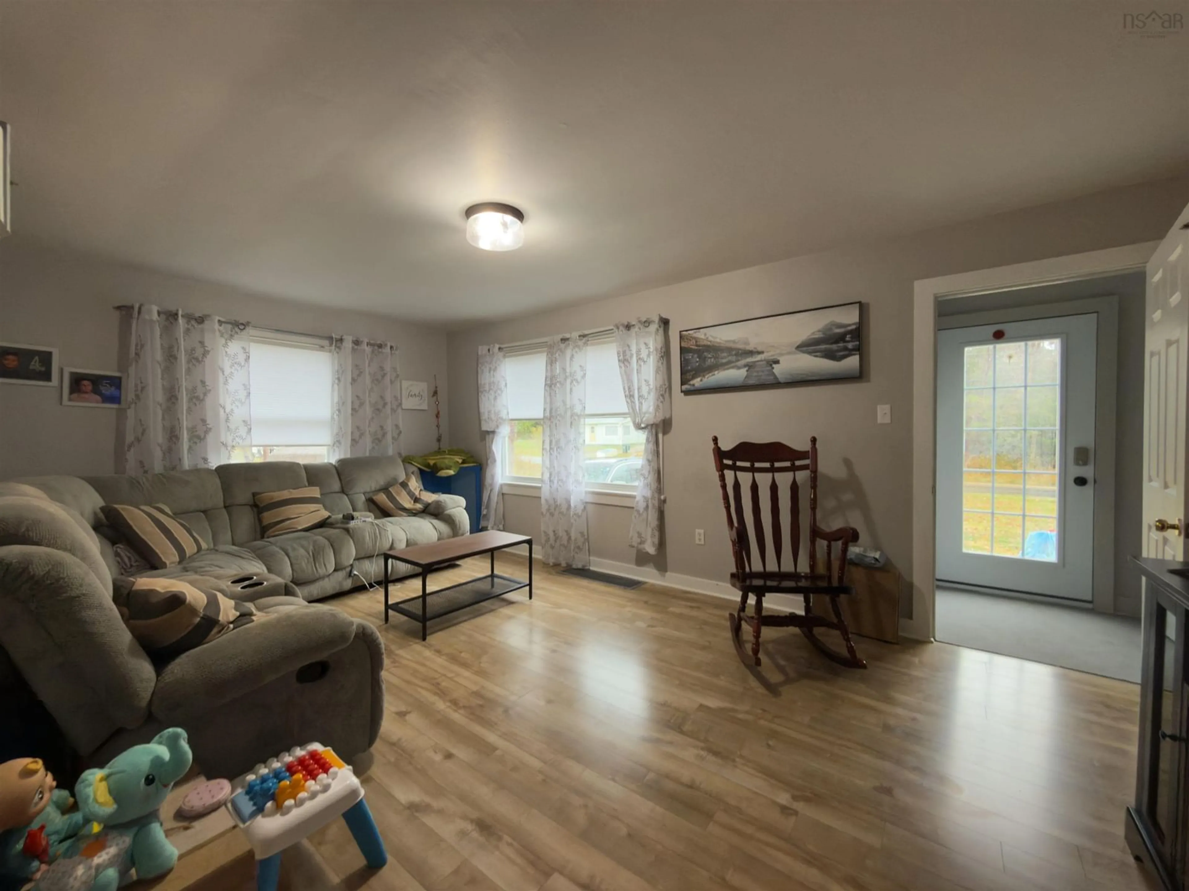 Living room with furniture, wood/laminate floor for 1090 Main Shore Rd, North Chegoggin Nova Scotia B5A 5H2