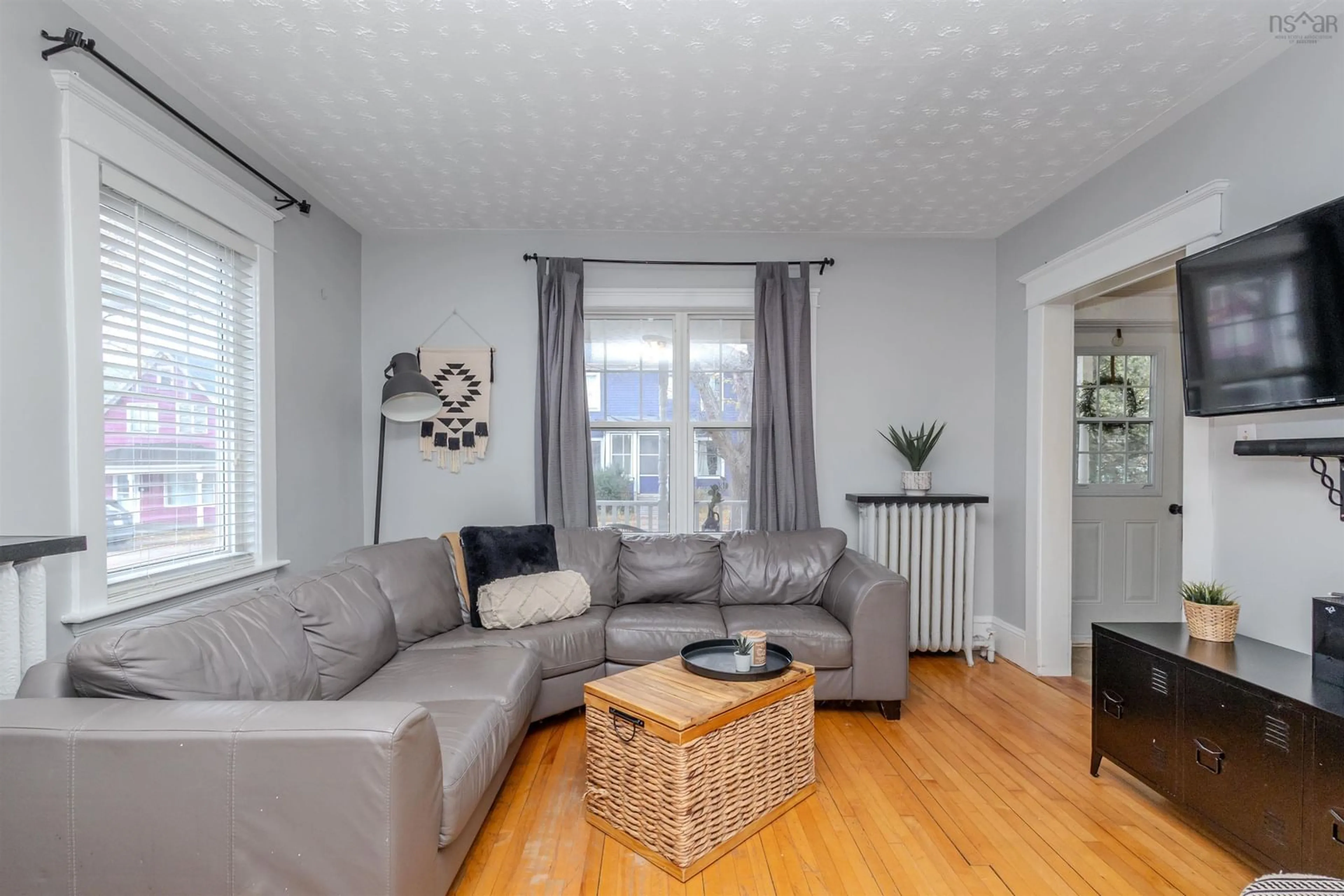 Living room with furniture, wood/laminate floor for 54 Ankerville St, Sydney Nova Scotia B1P 1Y2