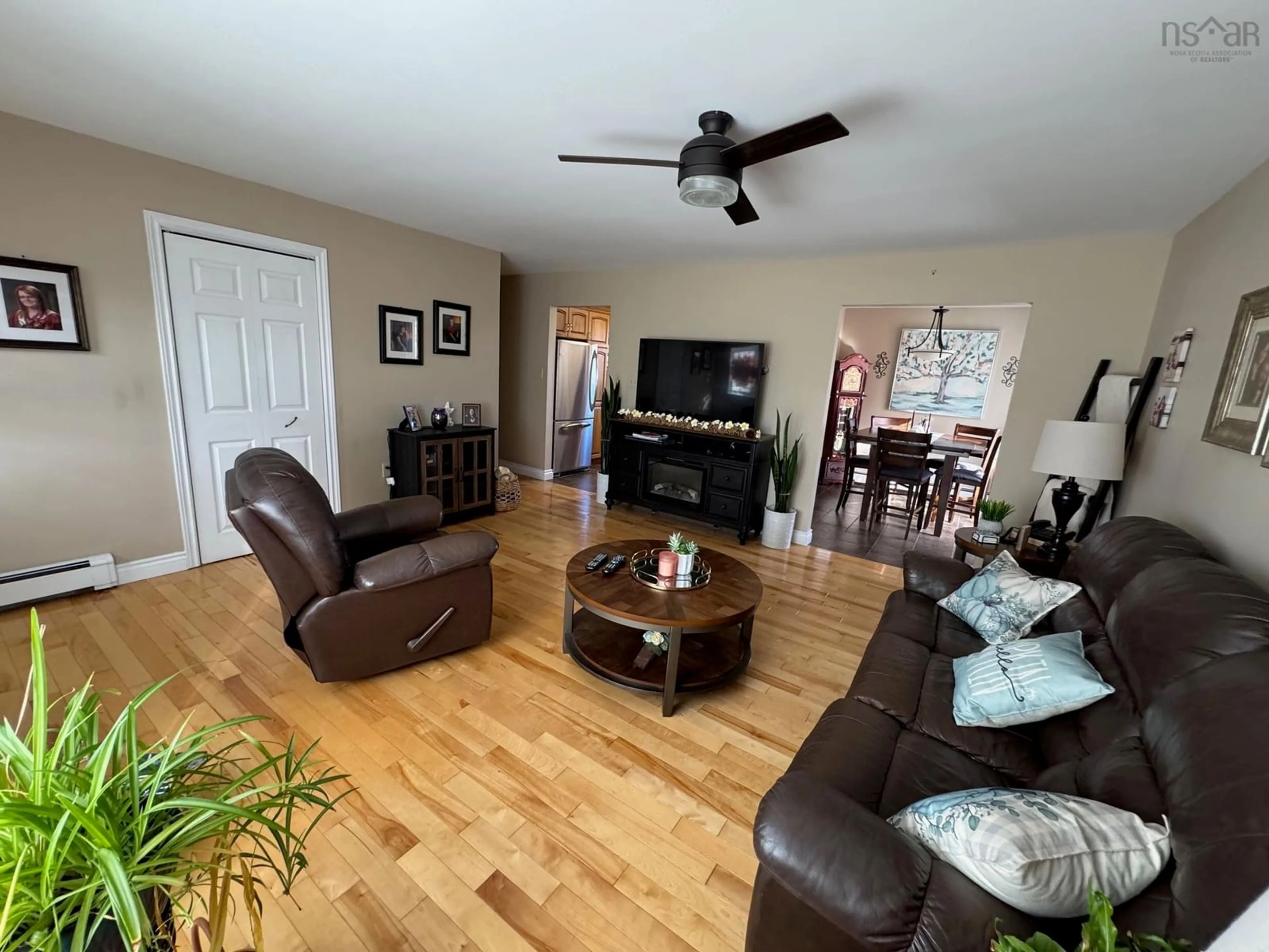 Living room with furniture, wood/laminate floor for 12 Lorway St, Louisbourg Nova Scotia B1C 2K1