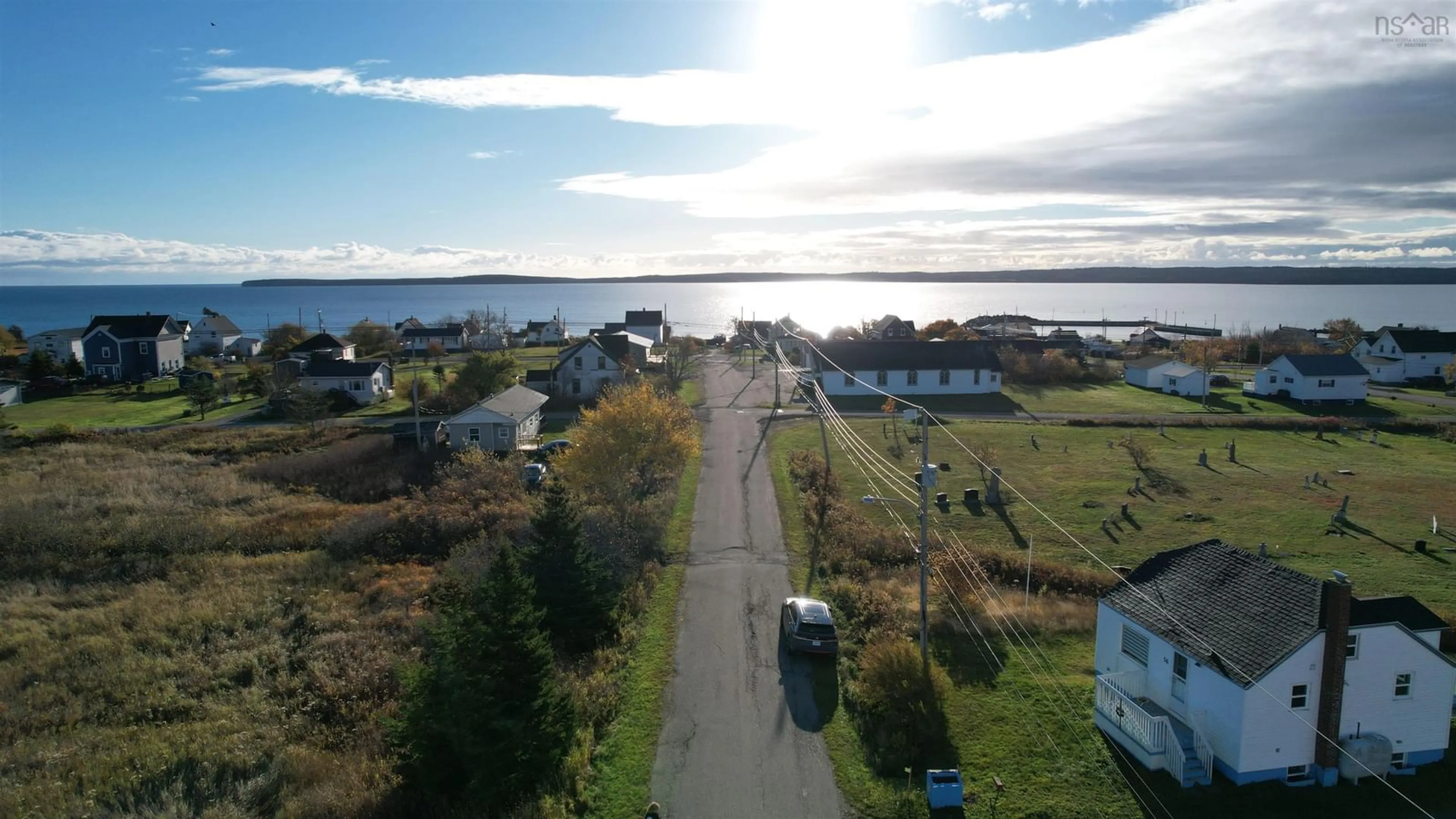 A pic from outside/outdoor area/front of a property/back of a property/a pic from drone, water/lake/river/ocean view for 56 Birch St, Port Morien Nova Scotia B1A 2M6