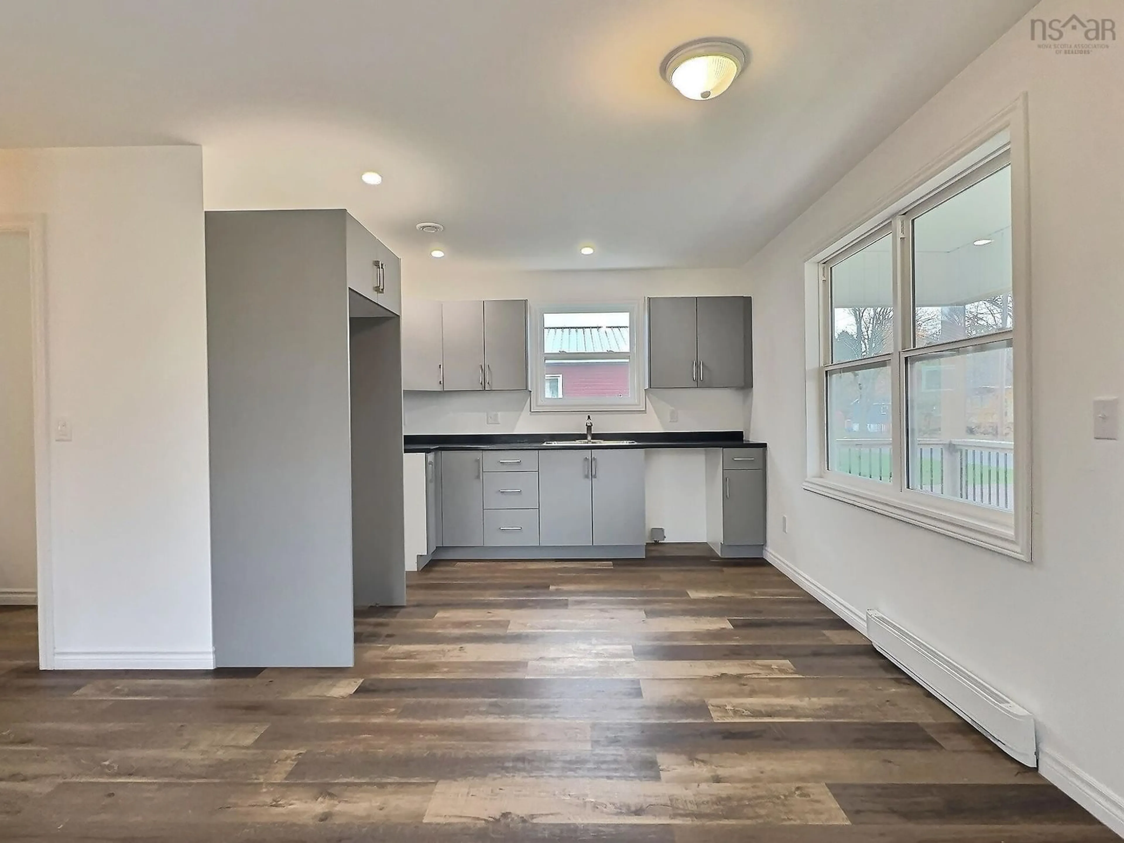 Open concept kitchen, wood/laminate floor for 53 Horton St, Oxford Nova Scotia B0M 1P0