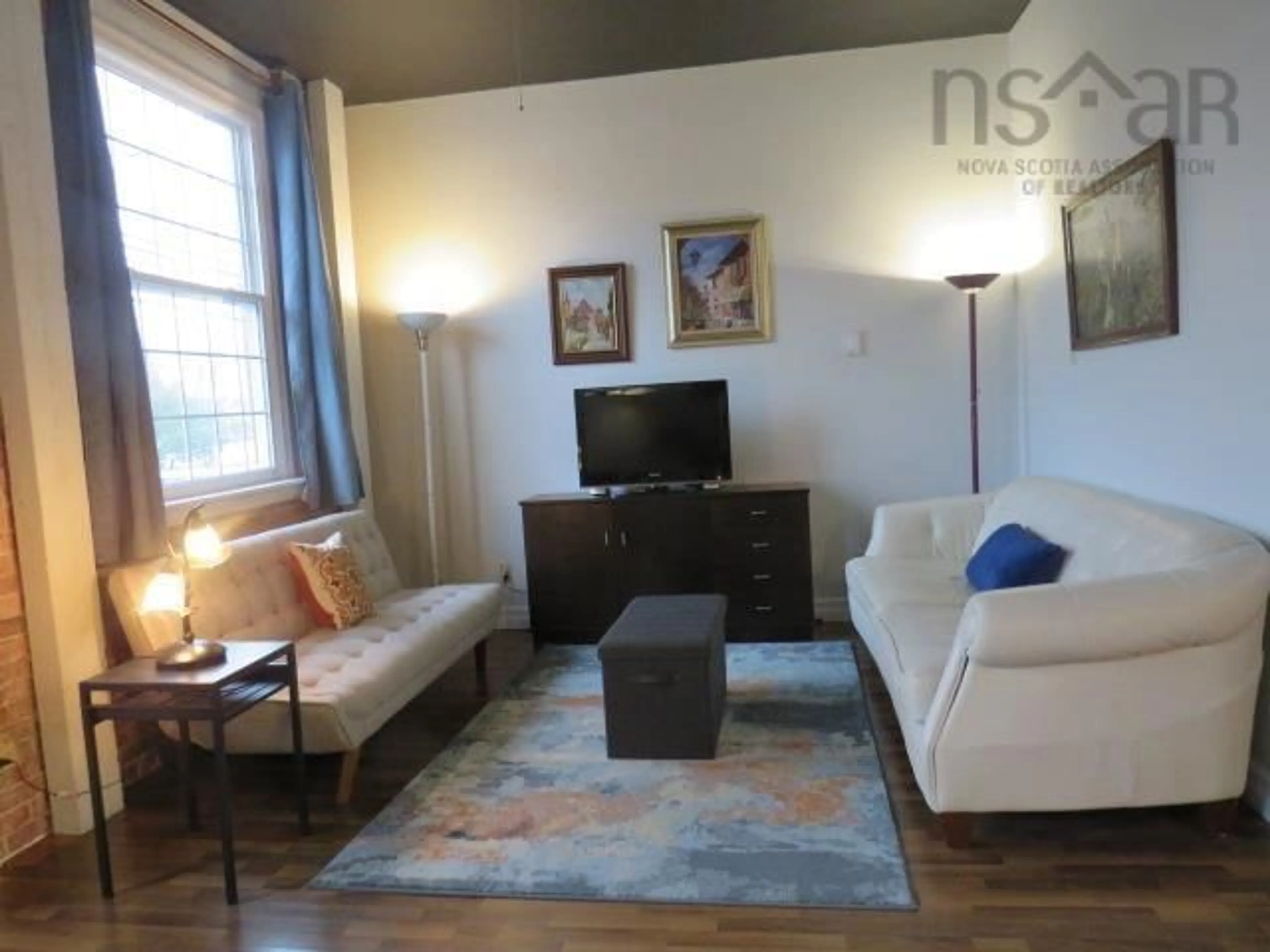 Living room with furniture, wood/laminate floor for 215 King St #207, Bridgewater Nova Scotia B4V 1A6
