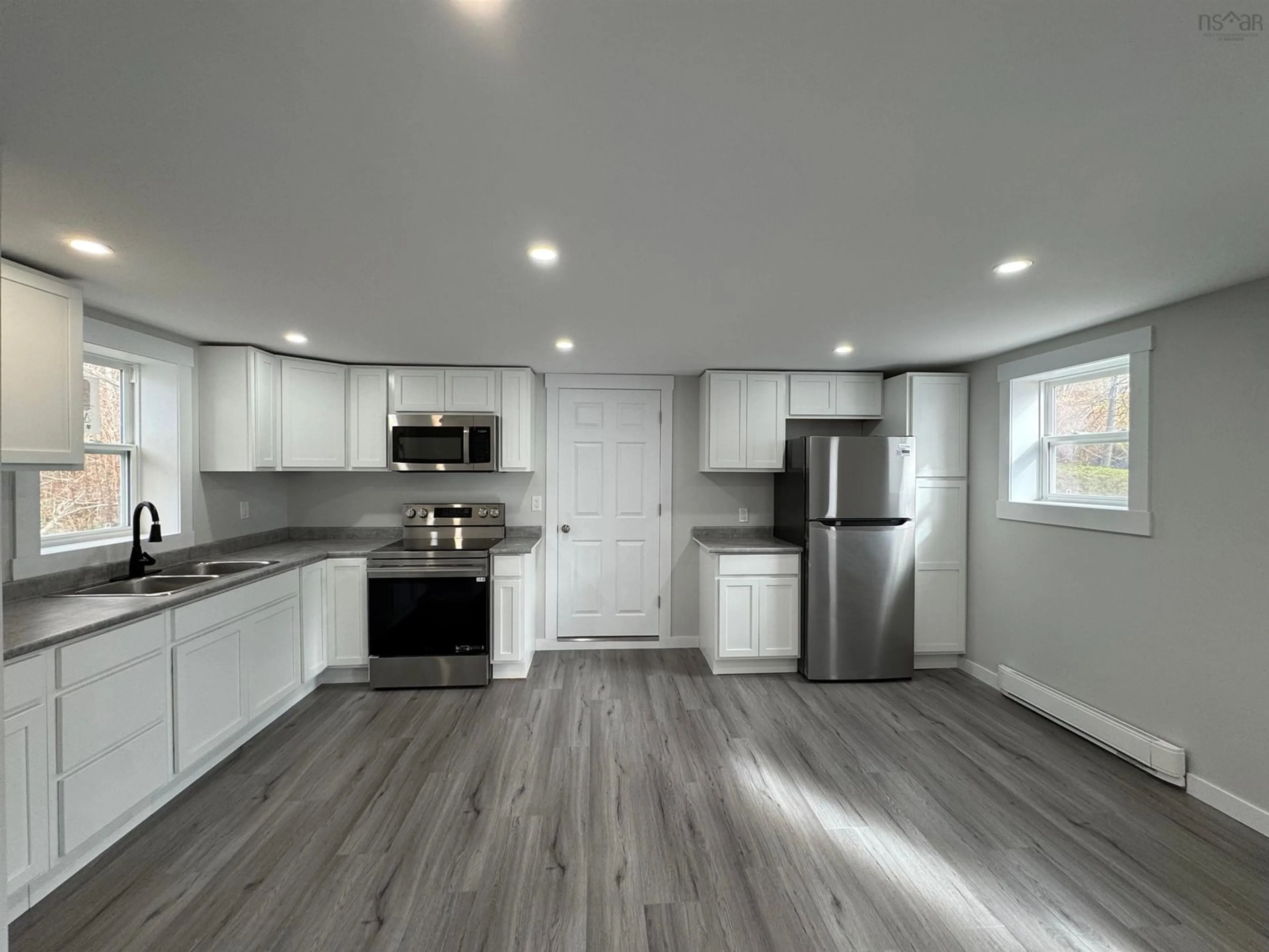 Open concept kitchen, wood/laminate floor for 164 Granville St, Port Hawkesbury Nova Scotia B9A 2G1