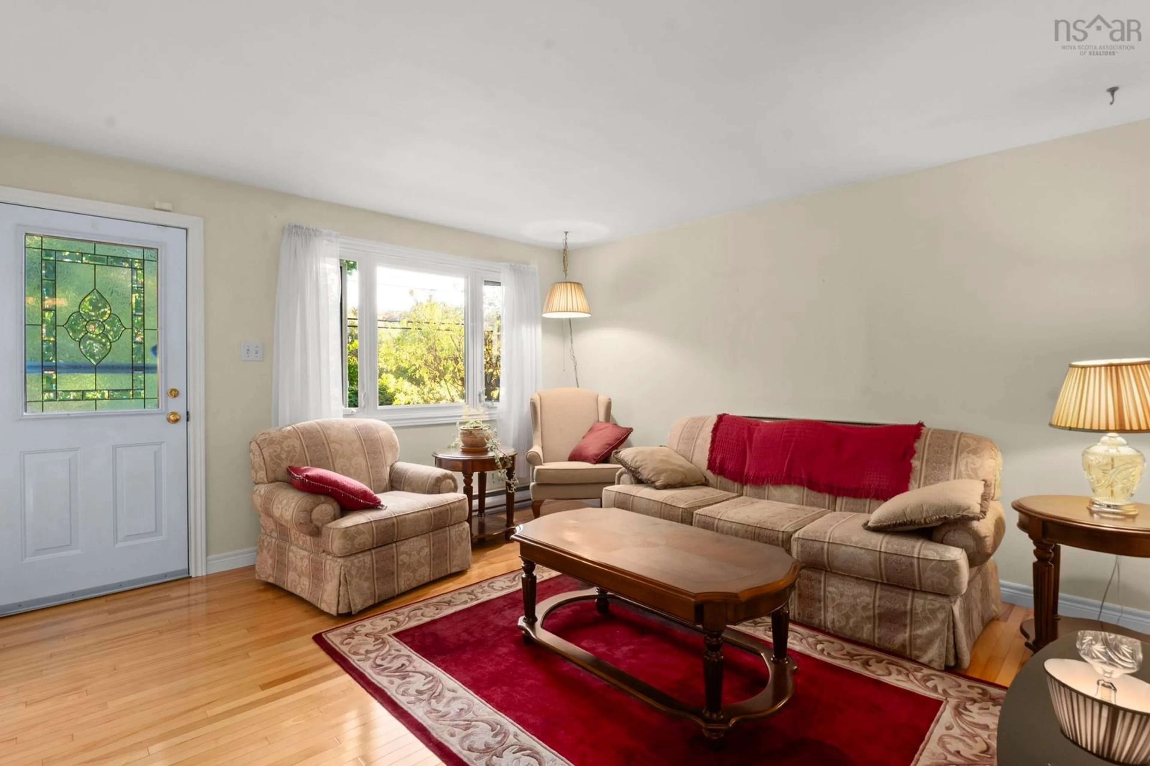 Living room with furniture, wood/laminate floor for 13 River Road, Halifax Nova Scotia B3R 1T9