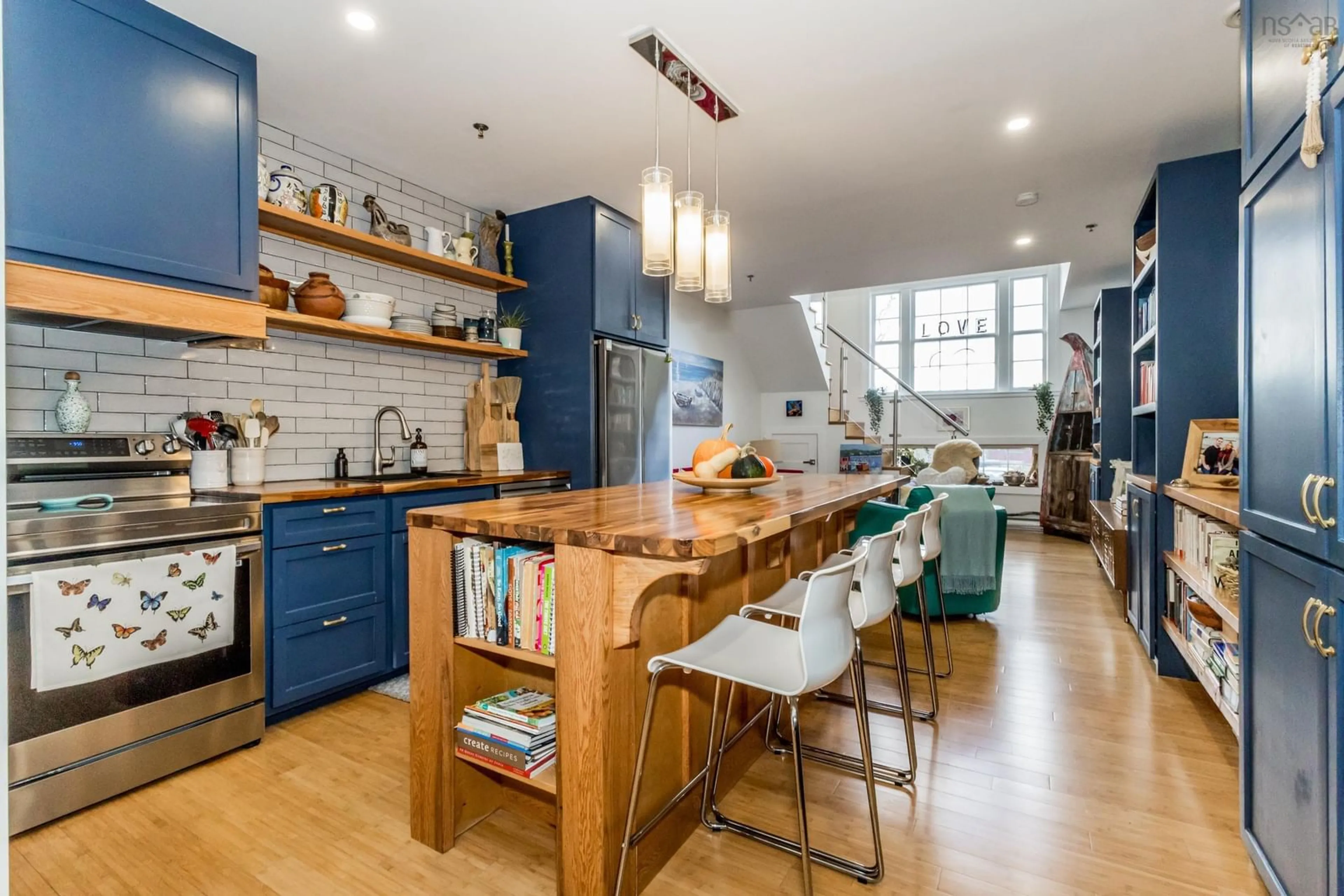 Open concept kitchen, wood/laminate floor for 151 Ritchie St #204, Annapolis Royal Nova Scotia B0S 1A0