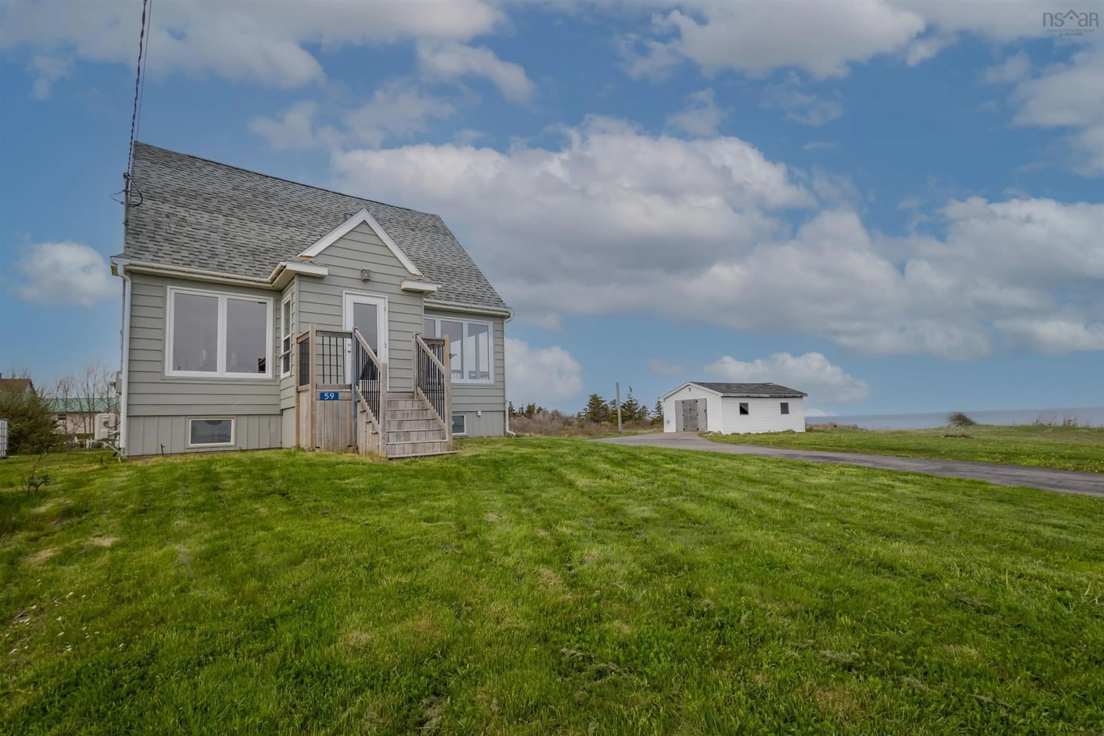 A pic from outside/outdoor area/front of a property/back of a property/a pic from drone, water/lake/river/ocean view for 59 Cliff St, Port Morien Nova Scotia B1B 1B4