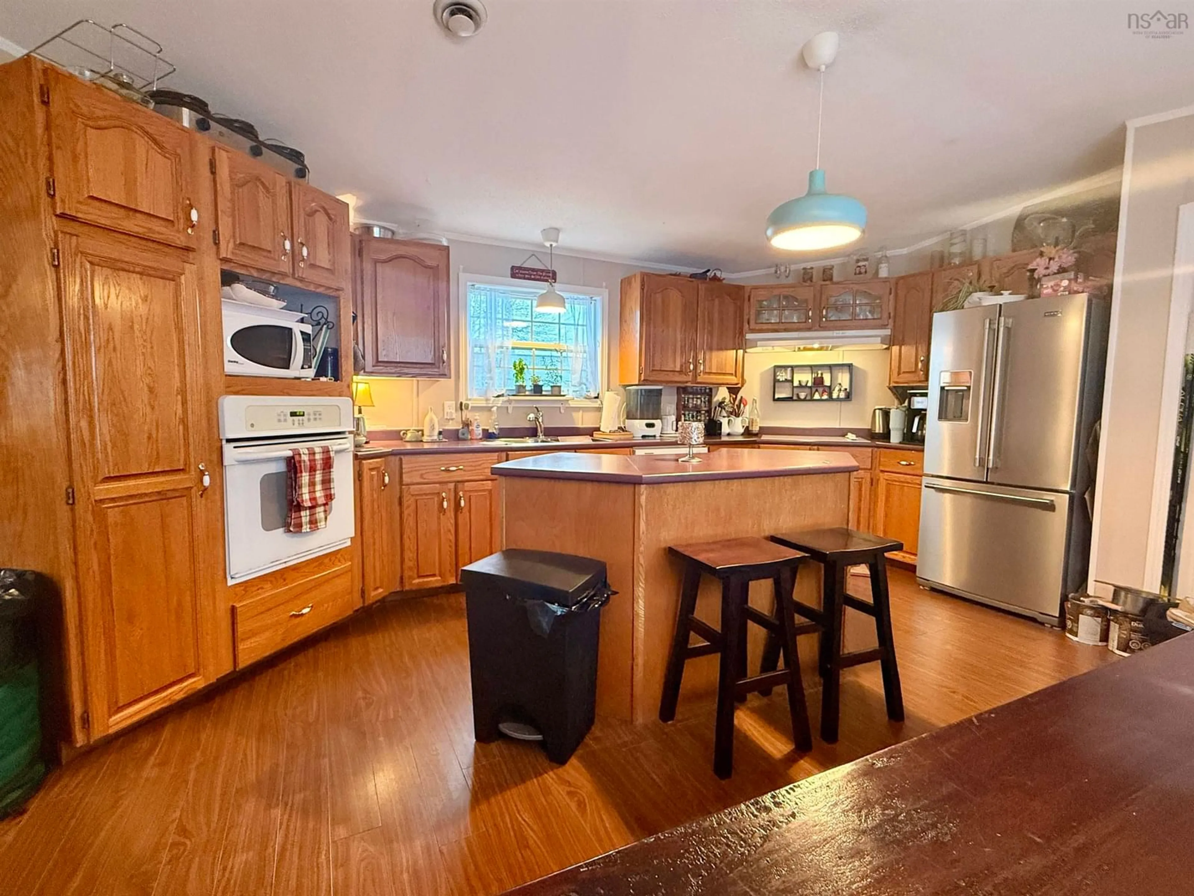 Open concept kitchen, wood/laminate floor for 24 Third St, Hammonds Plains Nova Scotia B4B 1P9