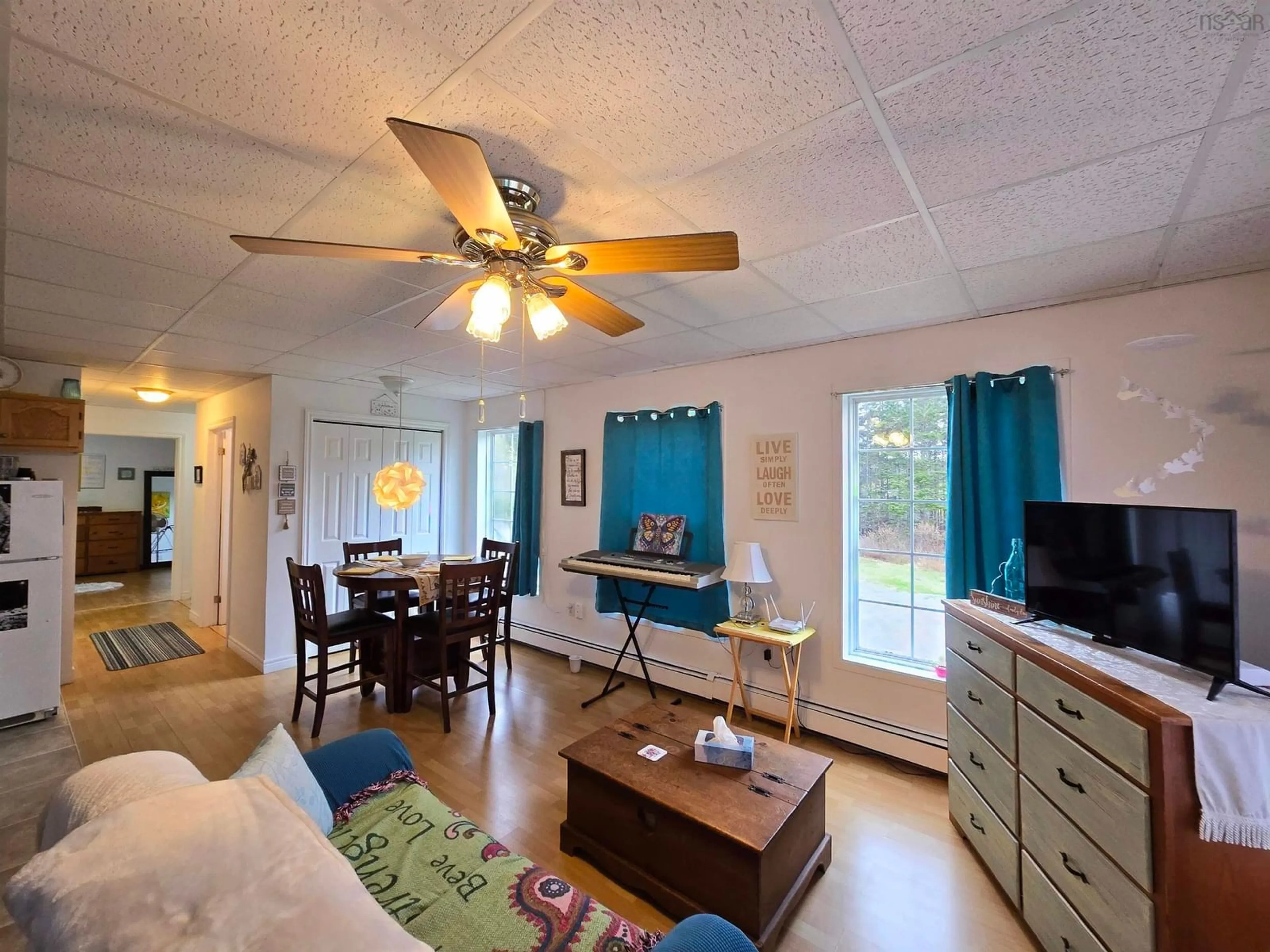 Living room with furniture, wood/laminate floor for 1826 St Peters Fourchu Rd, Grand River Nova Scotia B0E 1M0