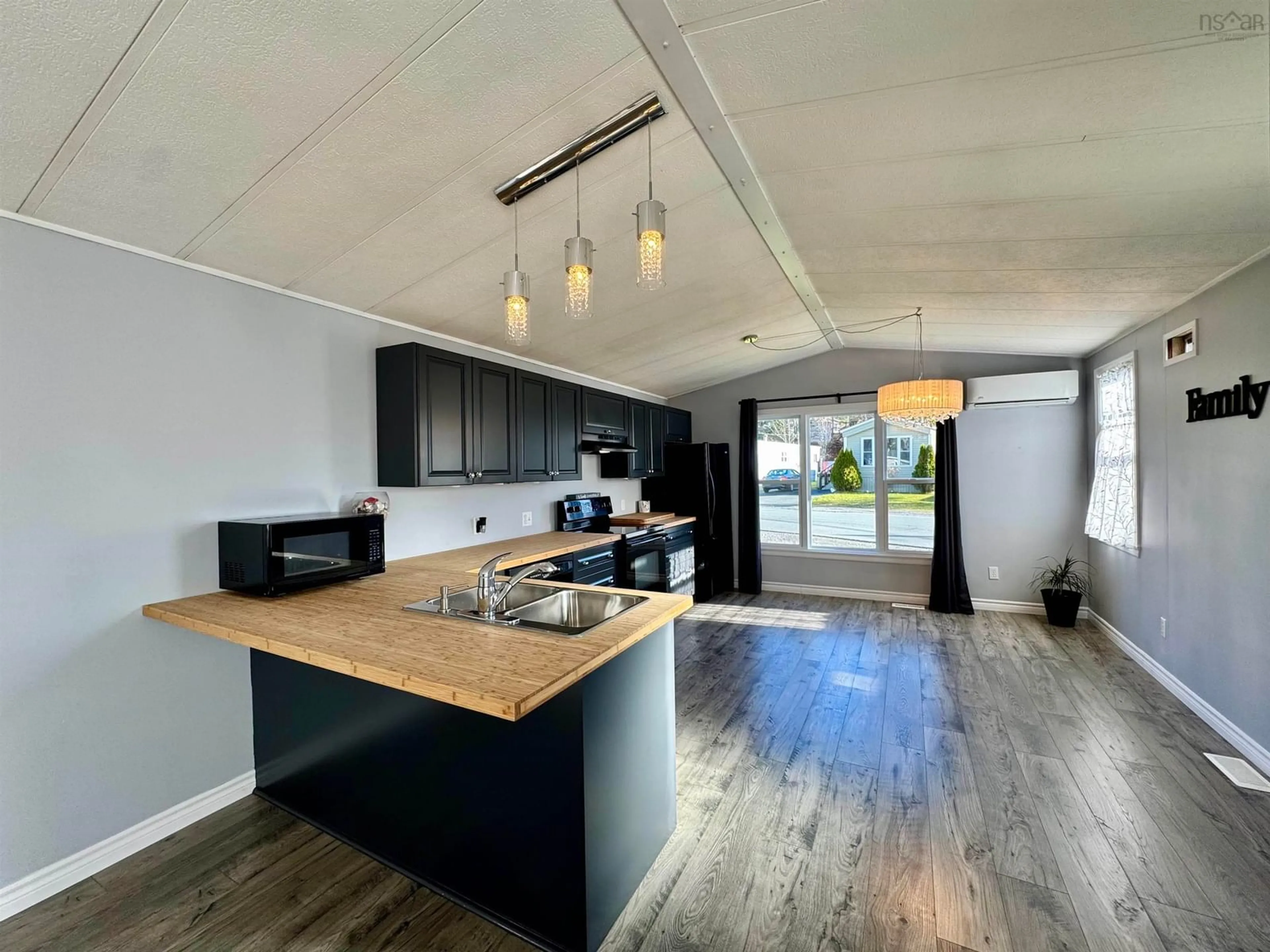 Open concept kitchen, wood/laminate floor for 1535 Woodbine Dr, Beaver Bank Nova Scotia B4E 2M7