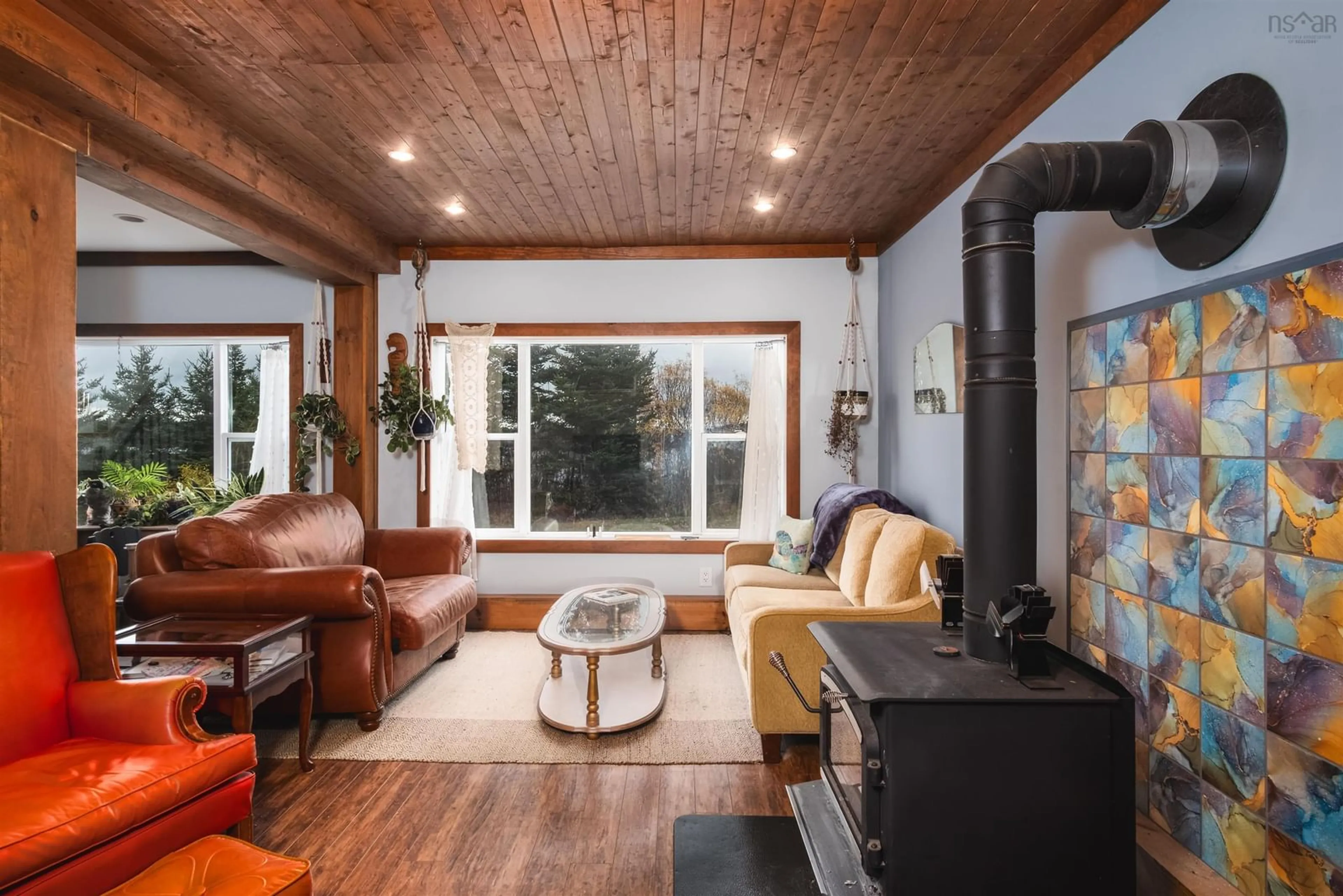 Living room with furniture, wood/laminate floor for 10198 Grenville St, St. Peter's Nova Scotia B0E 3B0