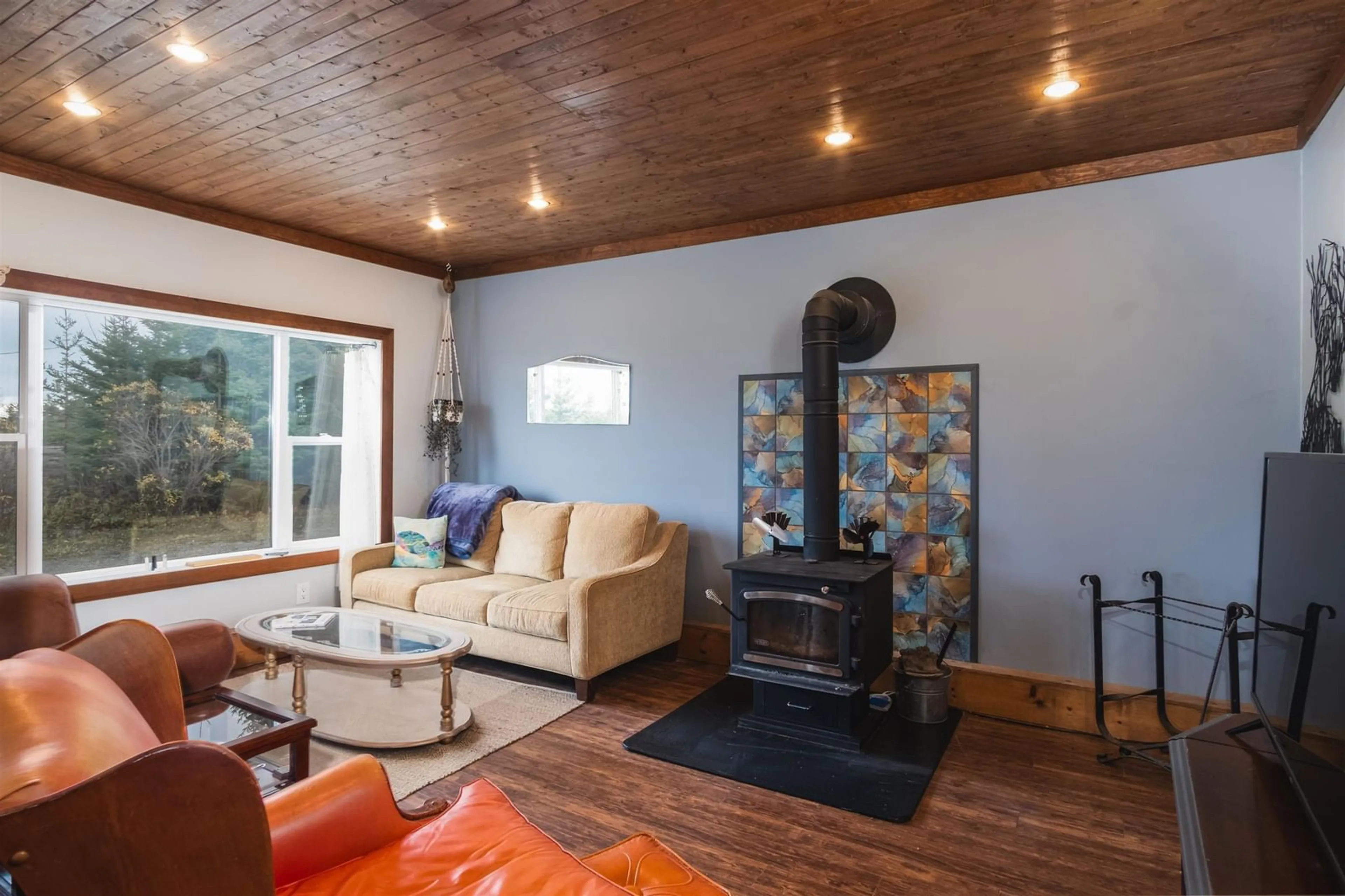 Living room with furniture, wood/laminate floor for 10198 Grenville St, St. Peter's Nova Scotia B0E 3B0