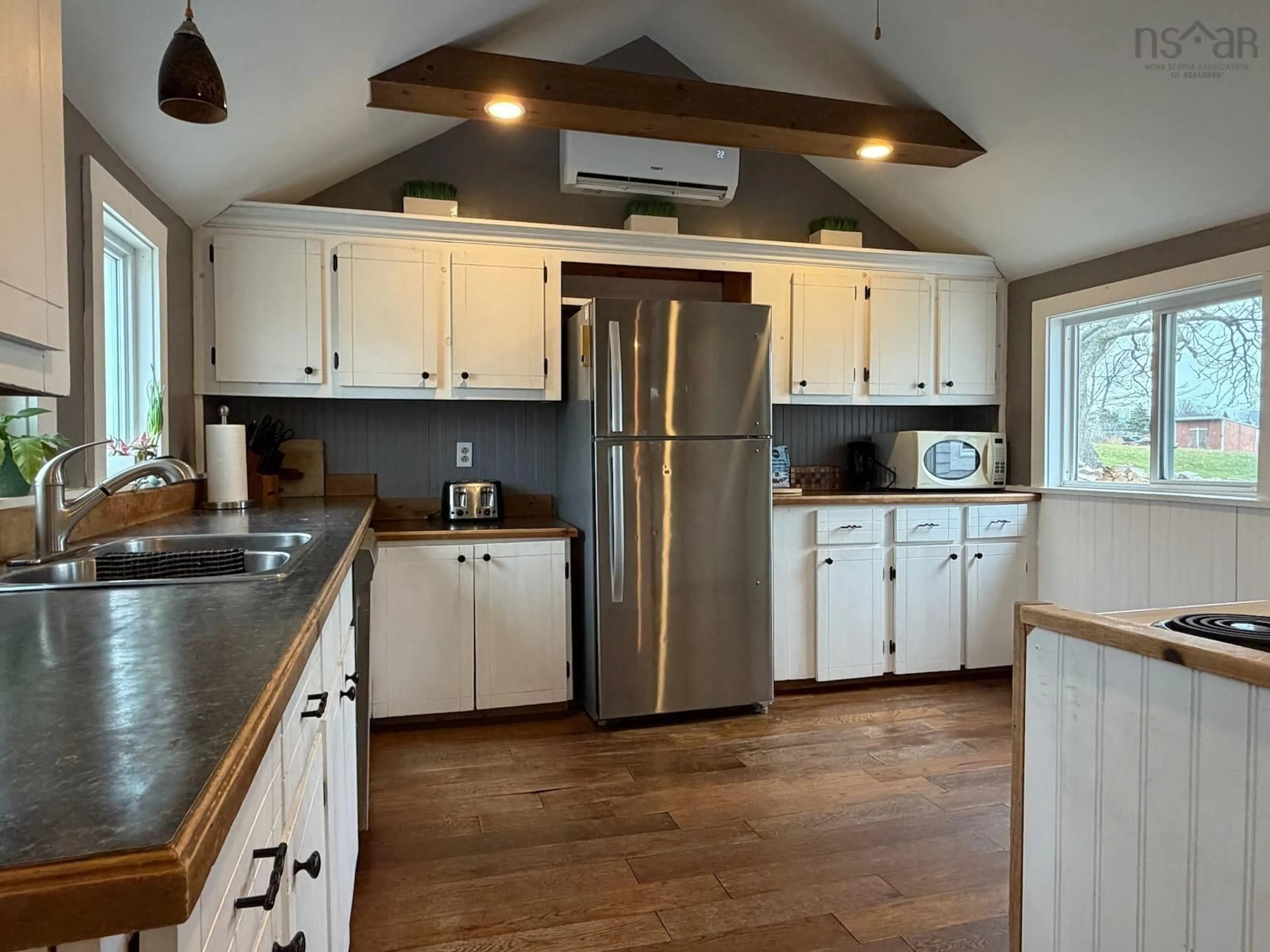 Open concept kitchen, wood/laminate floor for 156 Main Shore Rd, Milton Highlands Nova Scotia B5A 5H1