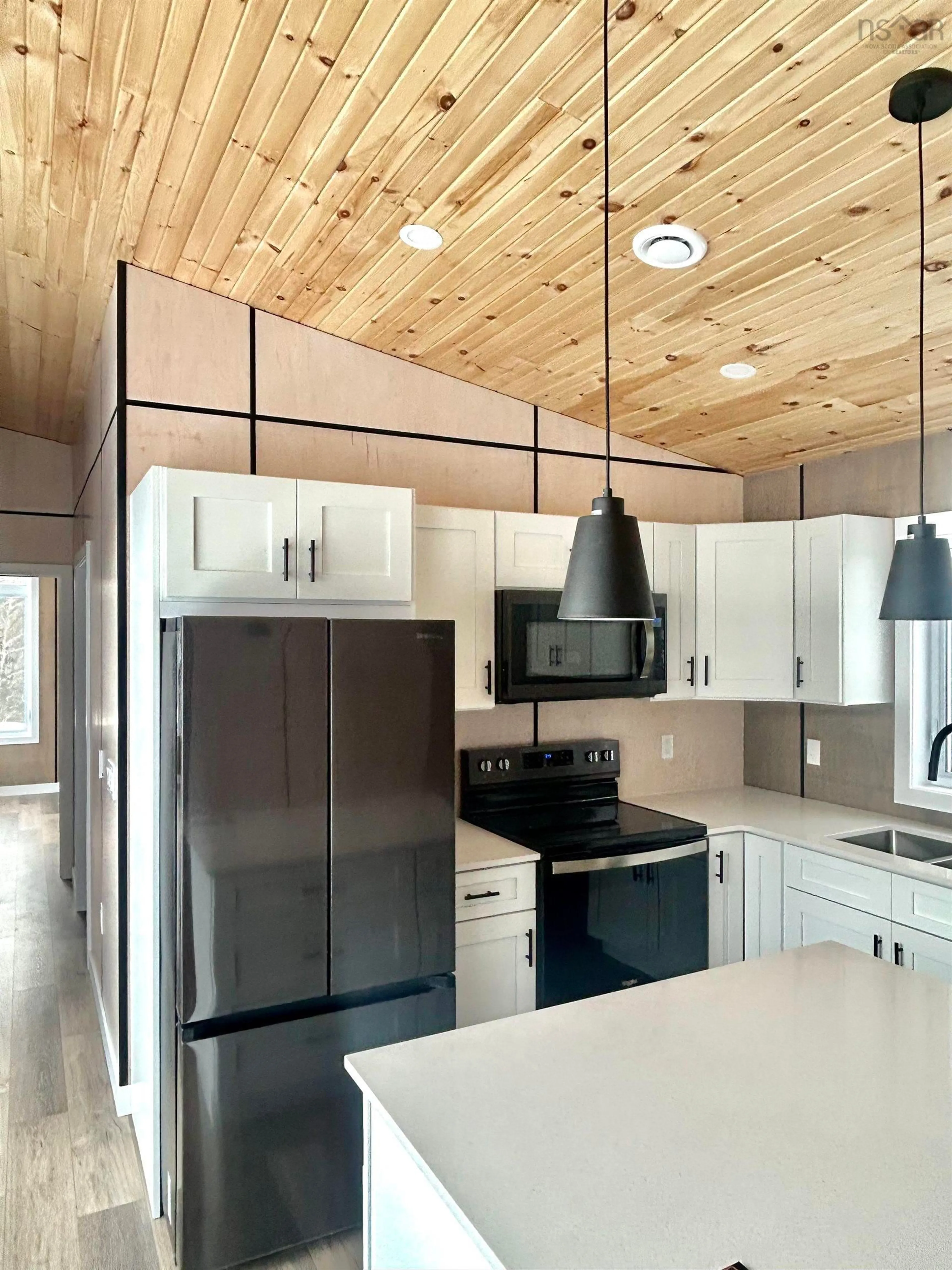 Open concept kitchen, wood/laminate floor for 25 Parkdale Cres, Inverness Nova Scotia B0E 1N0