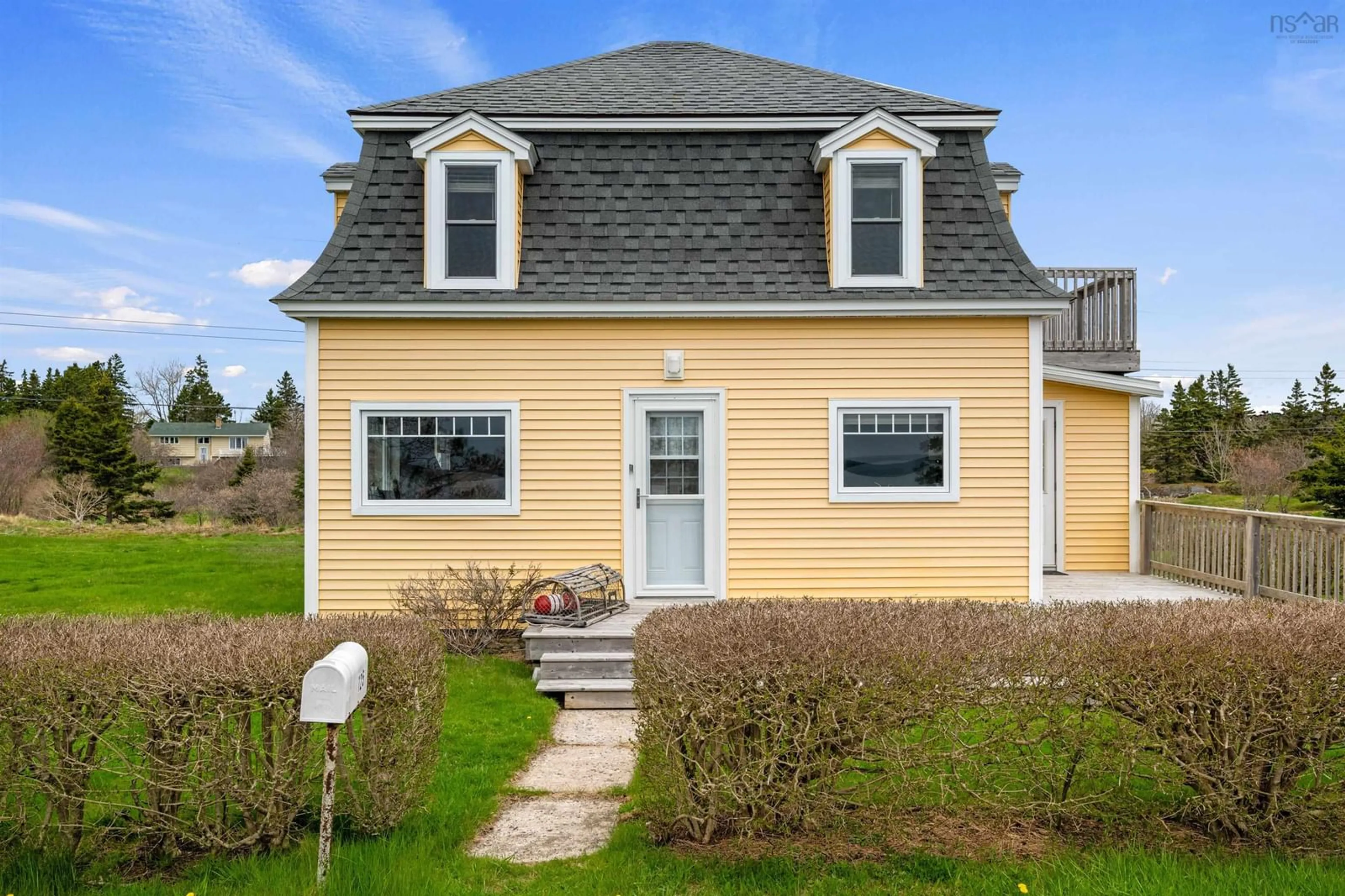 Home with vinyl exterior material, street for 125 The Point Rd, Blue Rocks Nova Scotia B0J 2C0