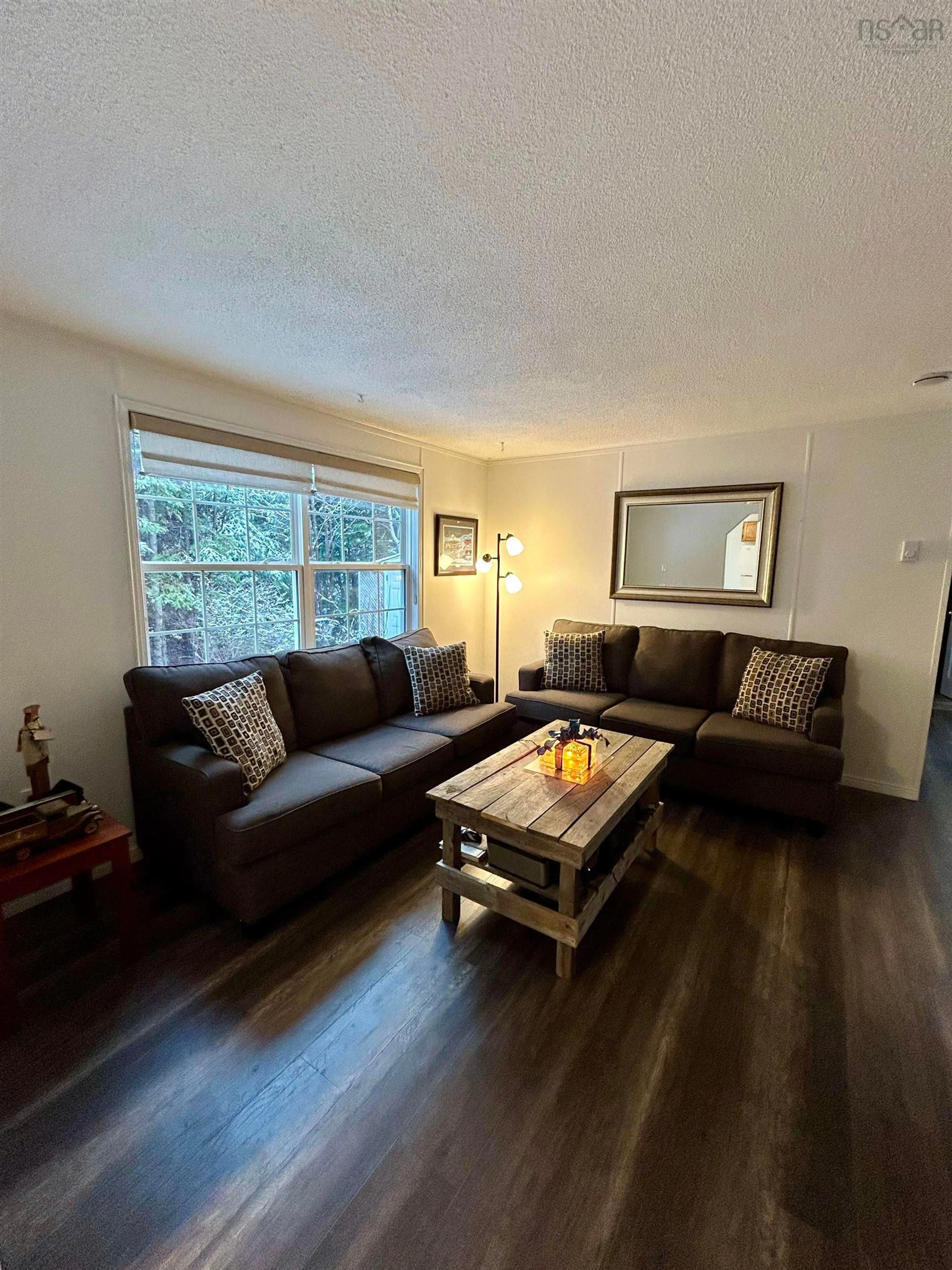 Living room with furniture, wood/laminate floor for 18 Lois Lane, Simms Settlement Nova Scotia B3P 2T3